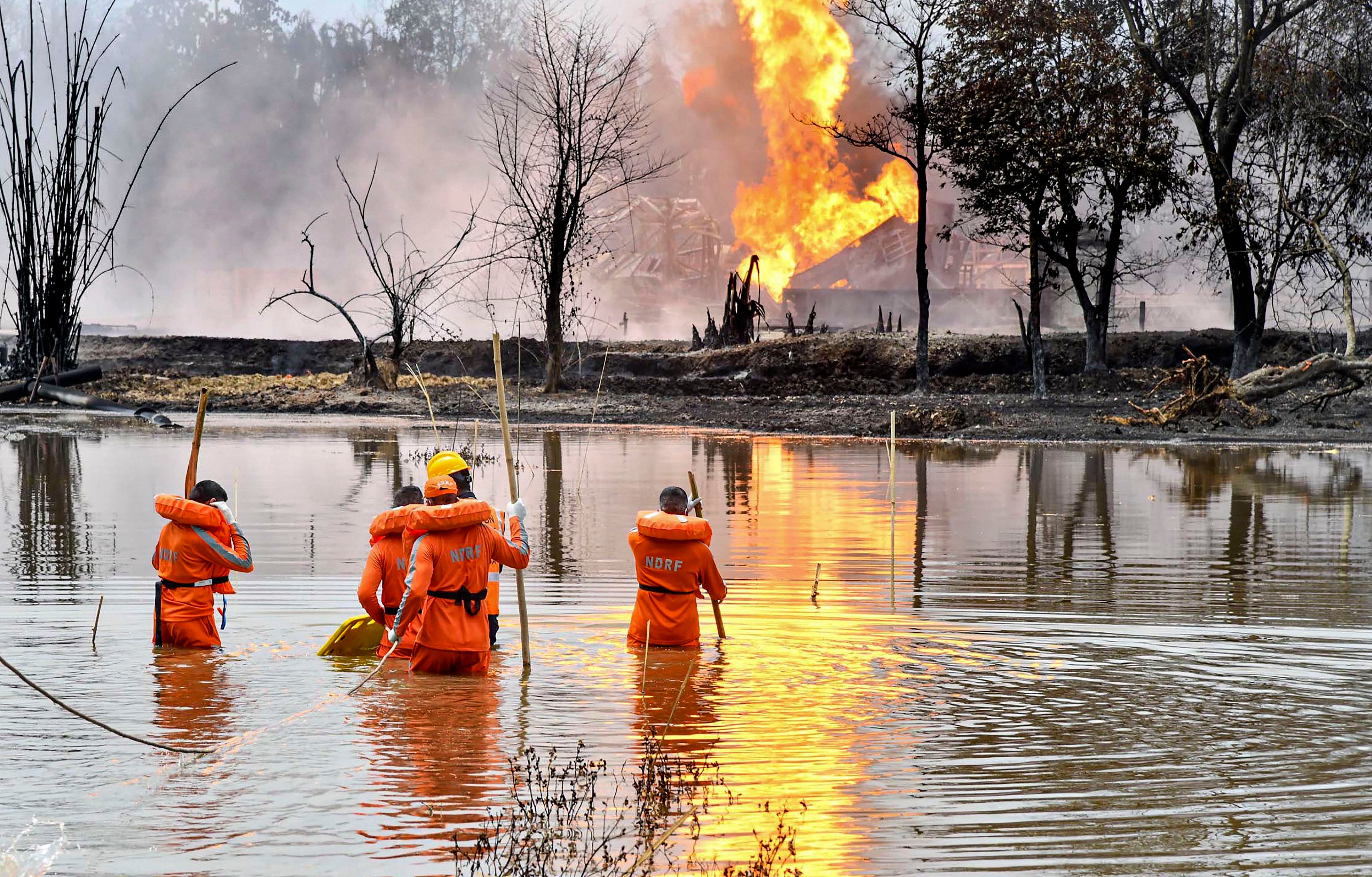 National Disaster Response Team (NDRF) personnel carry out search and rescue operations after two firemen of Oil India Limited went missing since an oil well at the company’s Baghjan oilfield exploded, in Assam’s Tinsukia district. Credit: PTI