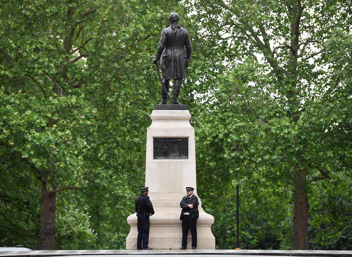 Police officers are seen on duty beside a statue of Clive of India in London, in the aftermath of protests against the death of George Floyd (Reuters Photo)