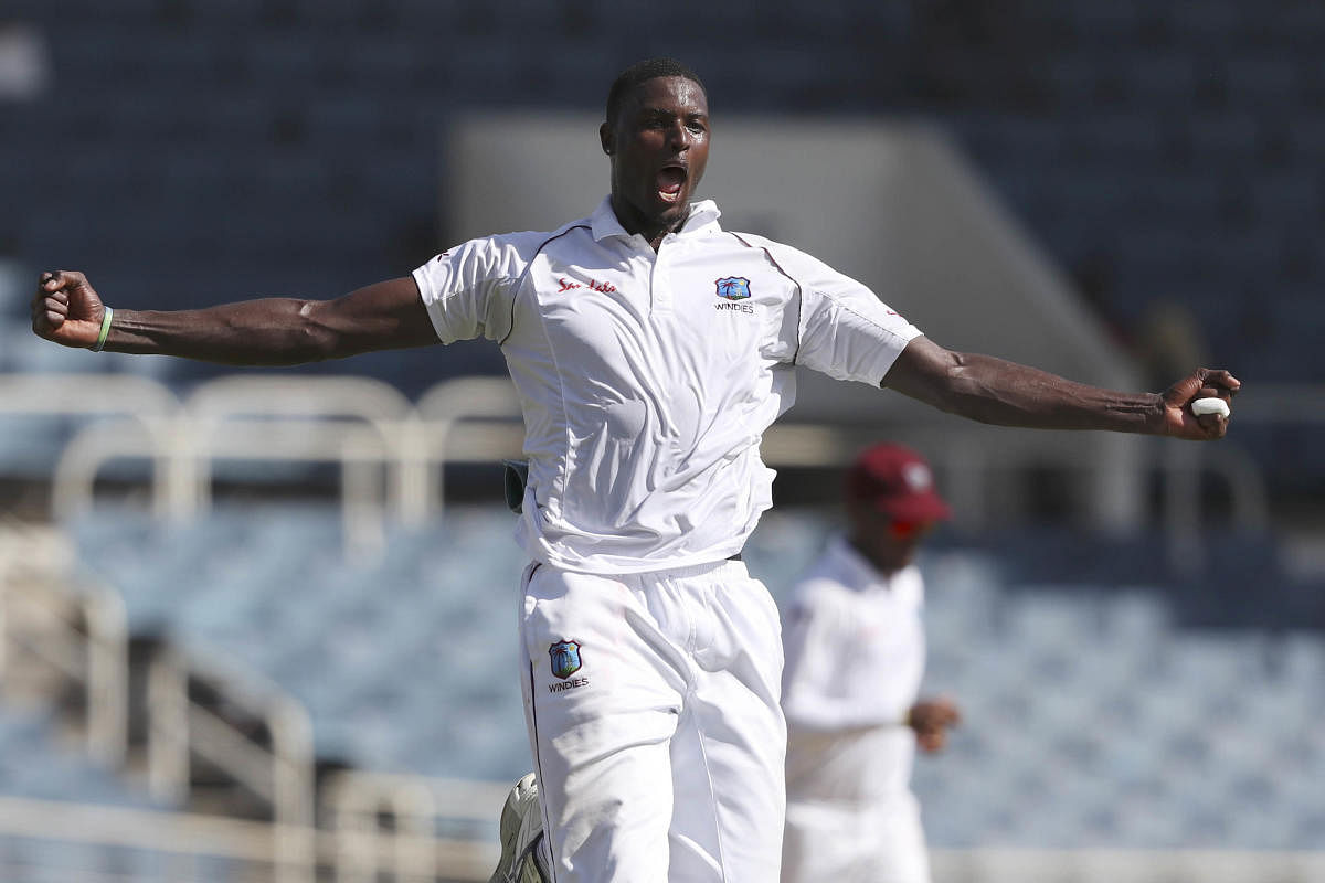 West Indies' captain Jason Holder celebrates taking the wicket of India's captain Virat Kohli during day one of the second Test cricket match at Sabina Park cricket ground in Kingston, Jamaica. Credit/AP Photo