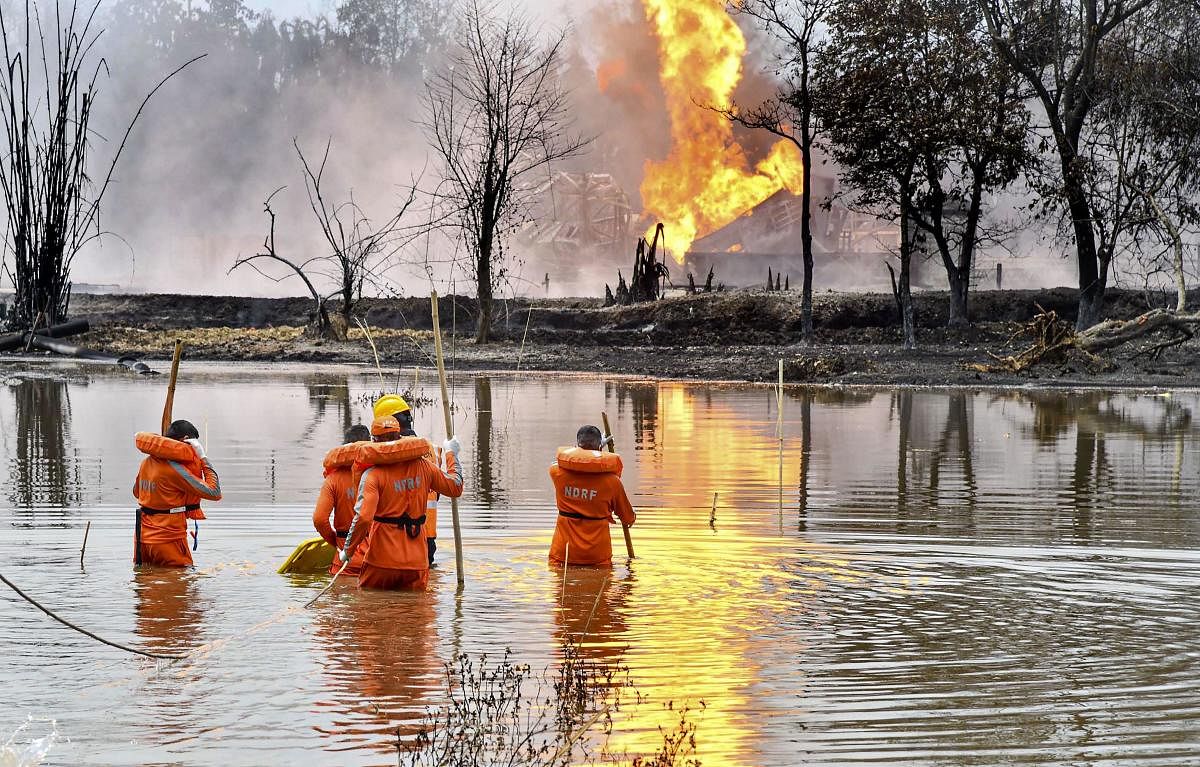  National Disaster Response Team (NDRF) personnel carry out search and rescue operations after two firemen of Oil India Limited went missing since an oil well at the company’s Baghjan oilfield exploded, in Assam’s Tinsukia district. Credit: PTI