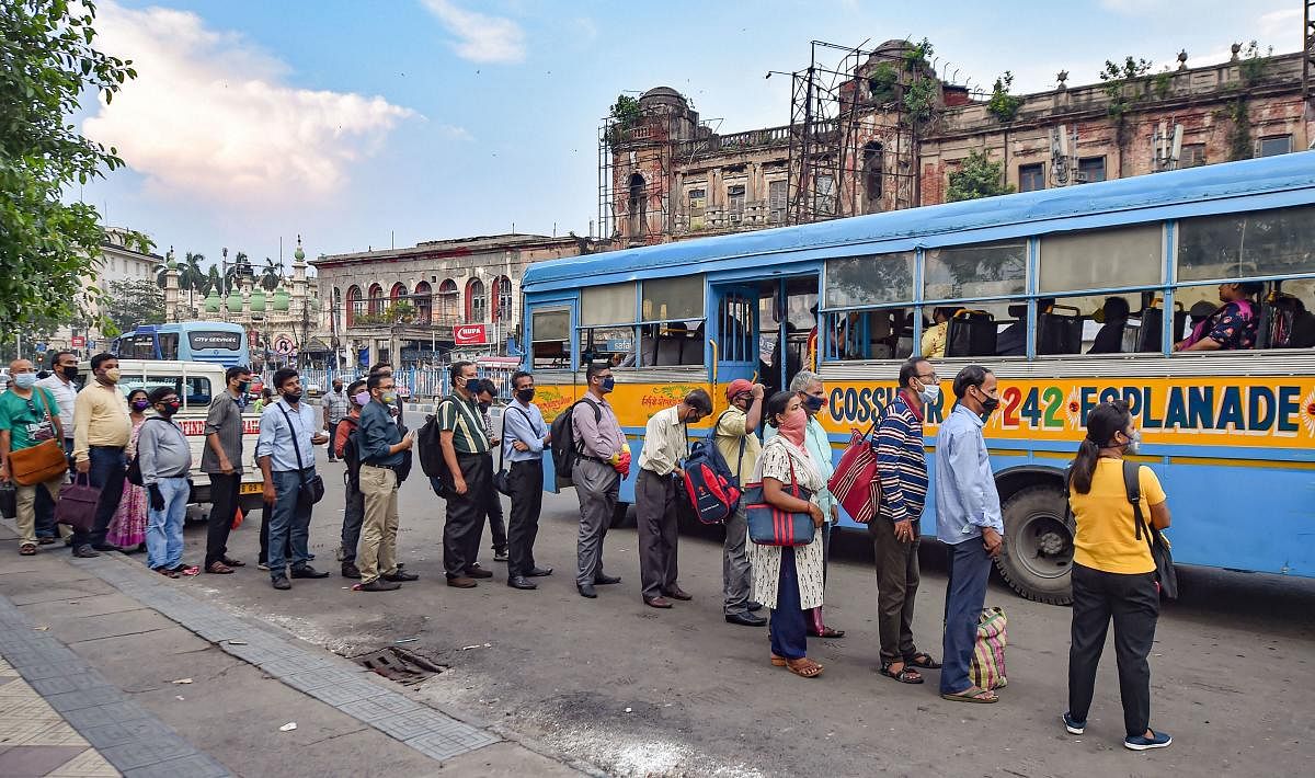 Kolkata: Commuters wait to board a bus to return home at the end of office hours, during the fifth phase of the nationwide COVID-19 lockdown, in Kolkata, Tuesday, June 9, 2020. (PTI Photo/Swapan Mahapatra)(PTI09-06-2020_000230A)