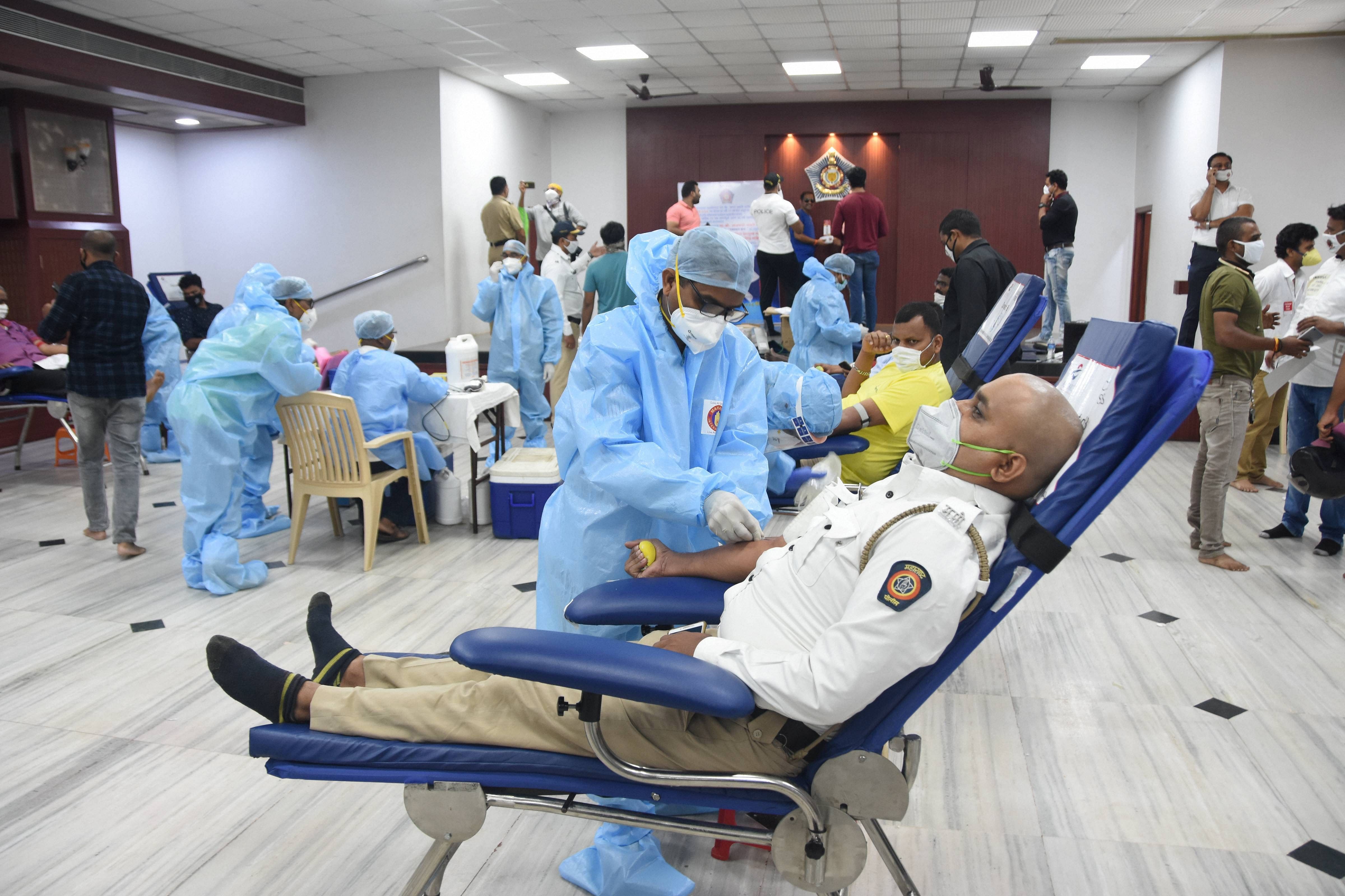 Police personnel donate blood after Maharashtra CM Uddhav Thackeray appealed donors to come forward due to the shortage of blood for COVID-19 and non-COVID patients, in Mumbai. Credits: PTI Photo