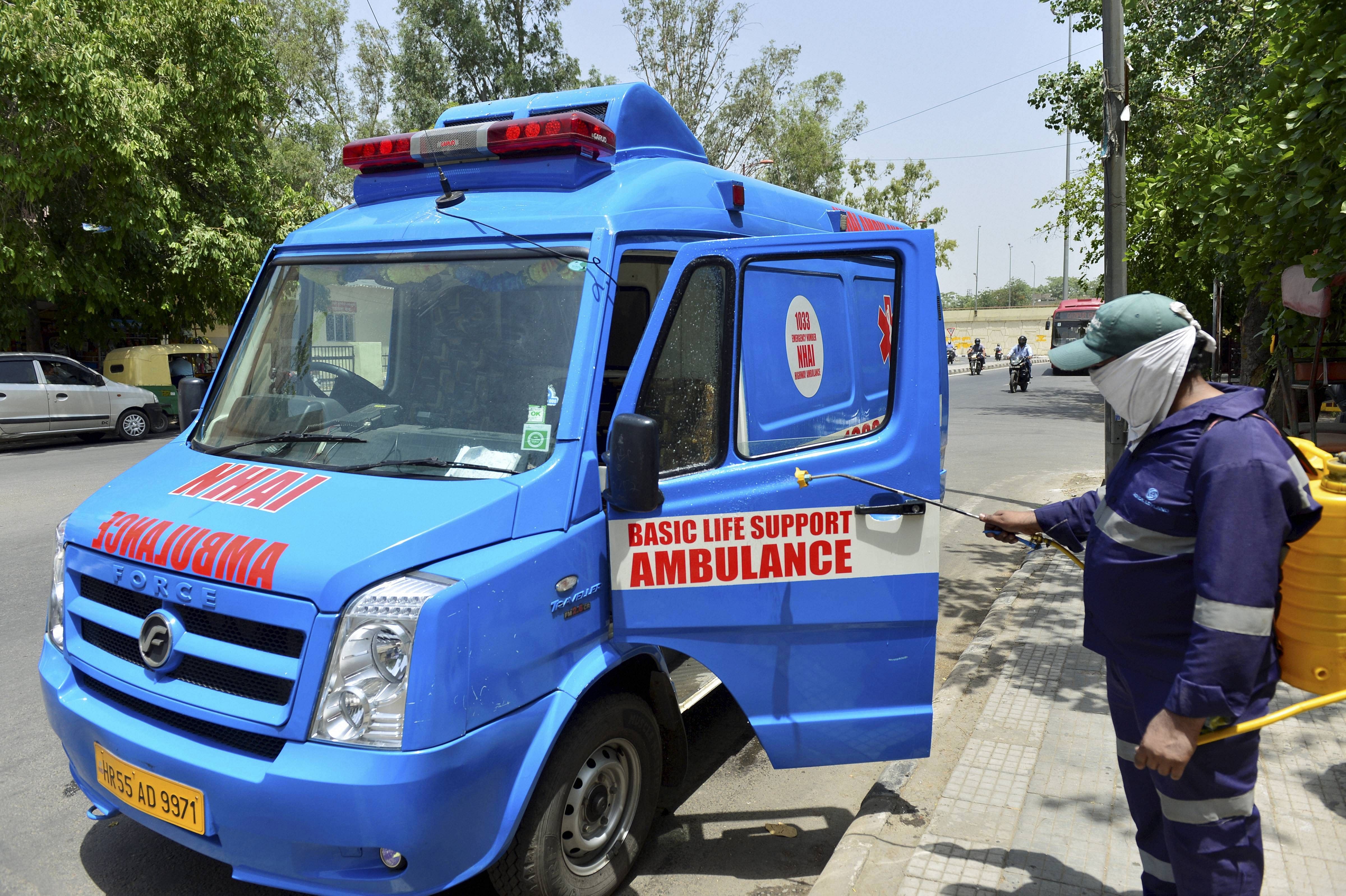 A MCD worker sprays disinfectant on an ambulance, in wake of the coronavirus pandemic, during the ongoing nationwide lockdown, in New Delhi. Credit: PTI