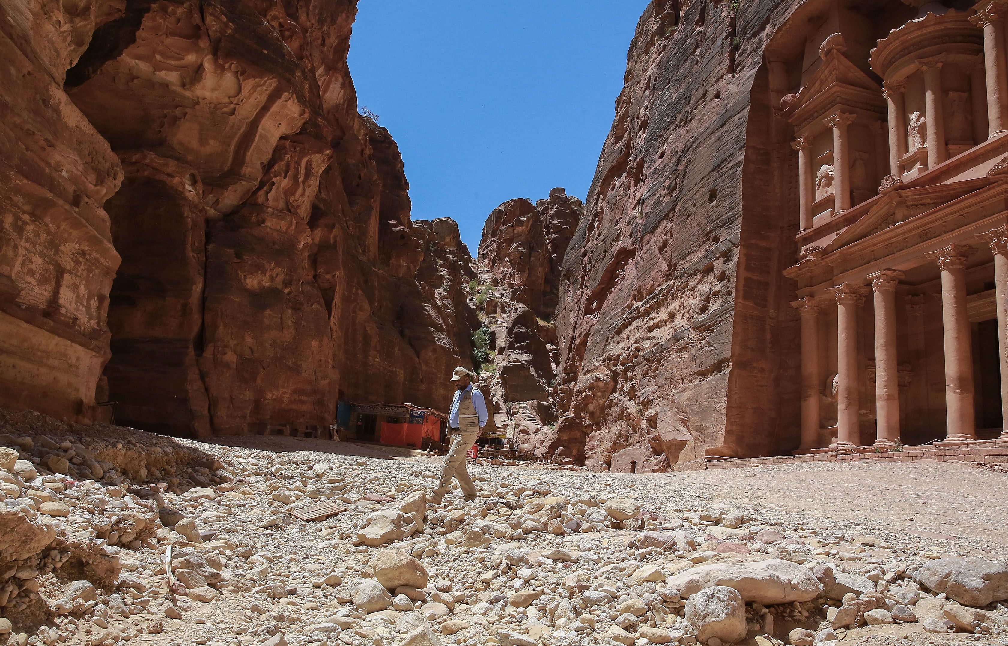 For over two millennia the ancient city of Petra has towered majestically over the Jordanian desert. Today its famed rose-red temples hewn into the rockface lie empty and silent. Credit: AFP Photo