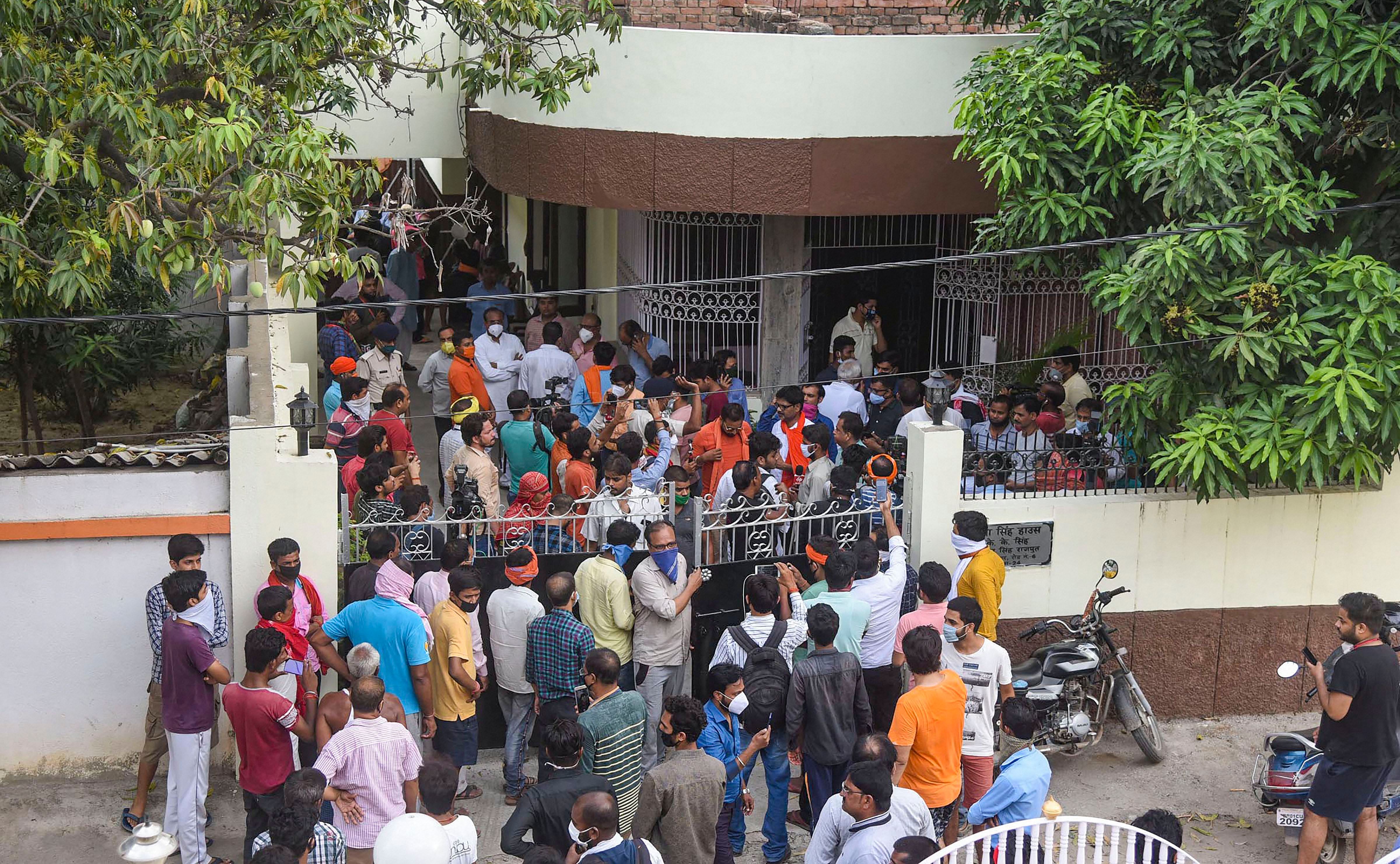 Kins and fans of Bollywood actor Sushant Singh Rajput gather outside his residence after he was found hanging at his Bandra (Mumbai) apartment, in Patna, Sunday, June 14, 2020. (PTI Photo)