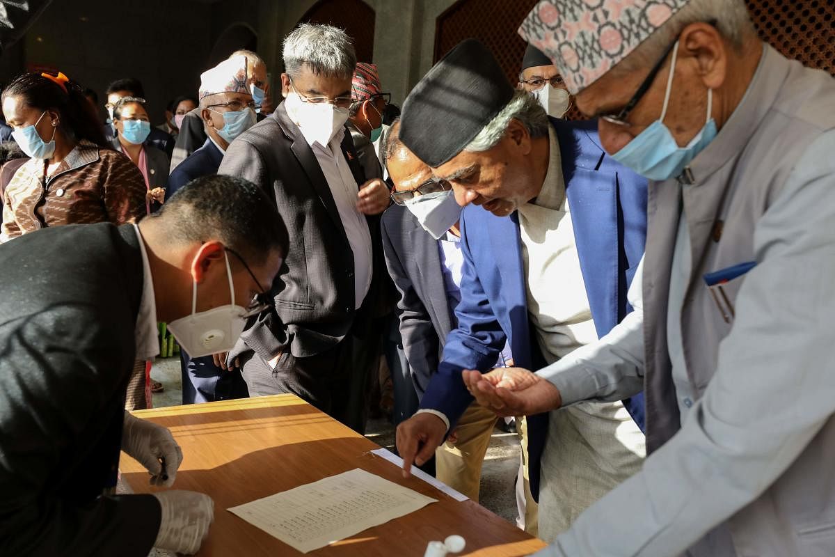 Representatives members sign as they vote on an amendment to update the national emblem with a new controversial political map in Kathmandu on June 13, 2020. Credit: AFP Photo