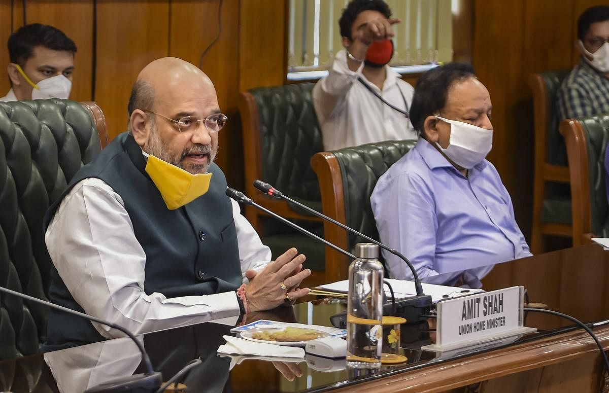 Union Home Minister Amit Shah with Health Minister Harsh Vardhan (R) holds a meeting to discuss the COVID-19 situation in Delhi, at North Block in New Delhi, Sunday, June 14, 2020. Credit/PTI Photo