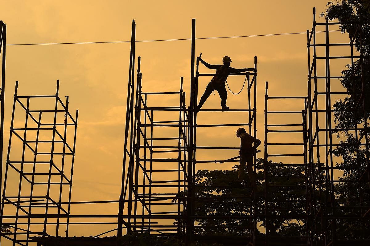 Labourers work at a construction site in New Delhi on June 13, 2020. (Photo by Money SHARMA / AFP)