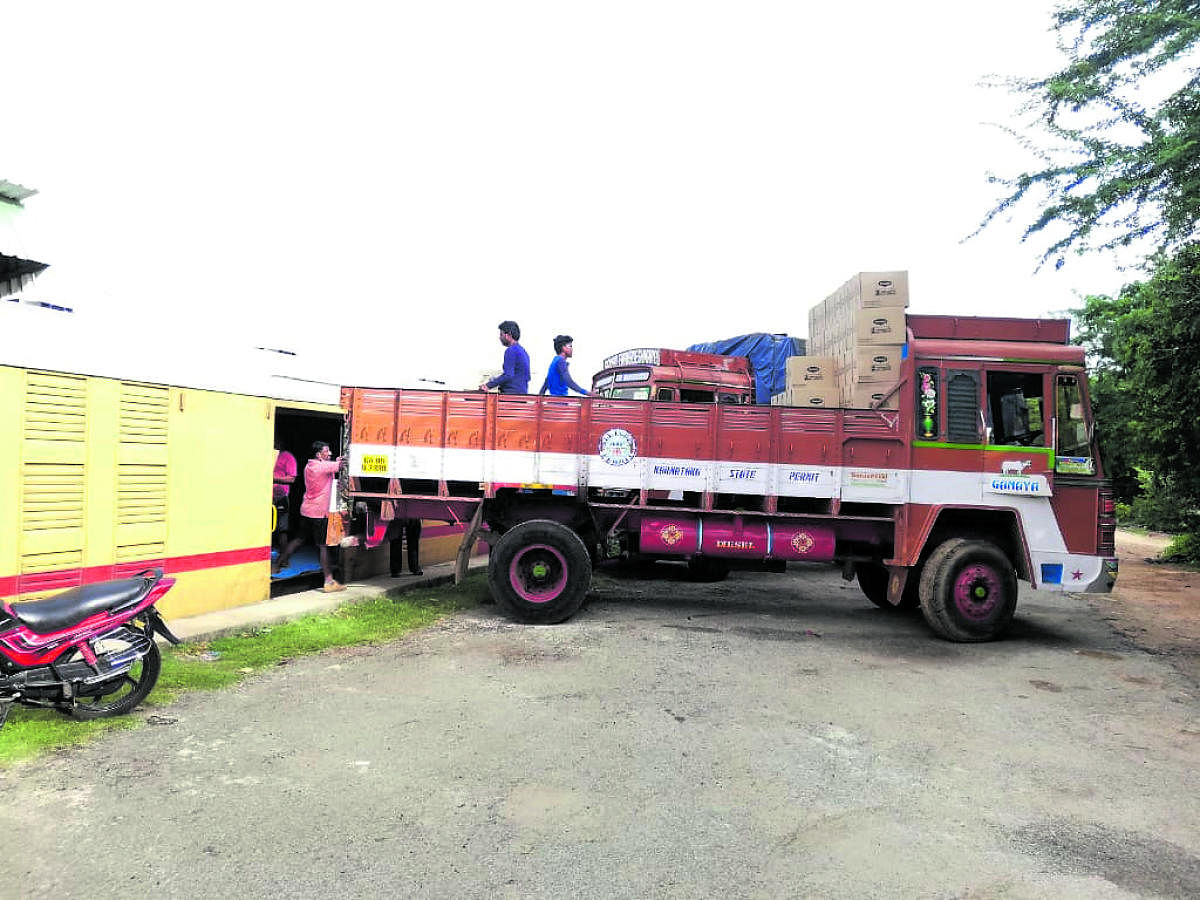 Workers load consignment to the Parcel Special Express train at Nanjangud Railway Station, Mysuru district, on Monday.
