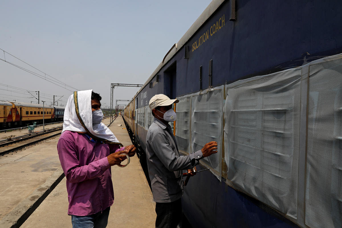 Workers fix mosquito nets on a parked passenger train that will be equipped for the care of coronavirus disease (COVID-19) patients amidst the spread of the disease, at a railway yard in New Delhi, India, June 15, 2020. Credit/Reuters Photo