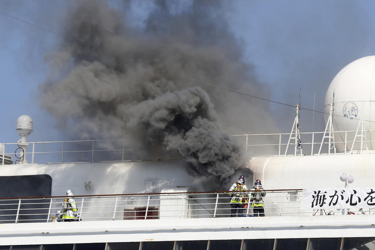 Smoke rises from Japanese cruise ship Asuka II docked in Yokohama Port, in Yokohama near Tokyo. AP/PTI