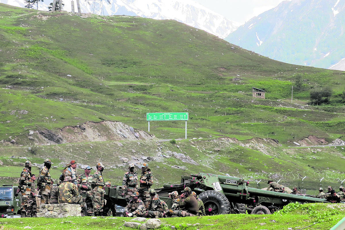 Indian army soldiers rest next to artillery guns at a makeshift transit camp before heading to Ladakh, near Baltal, southeast of Srinagar. Credit: Reuters