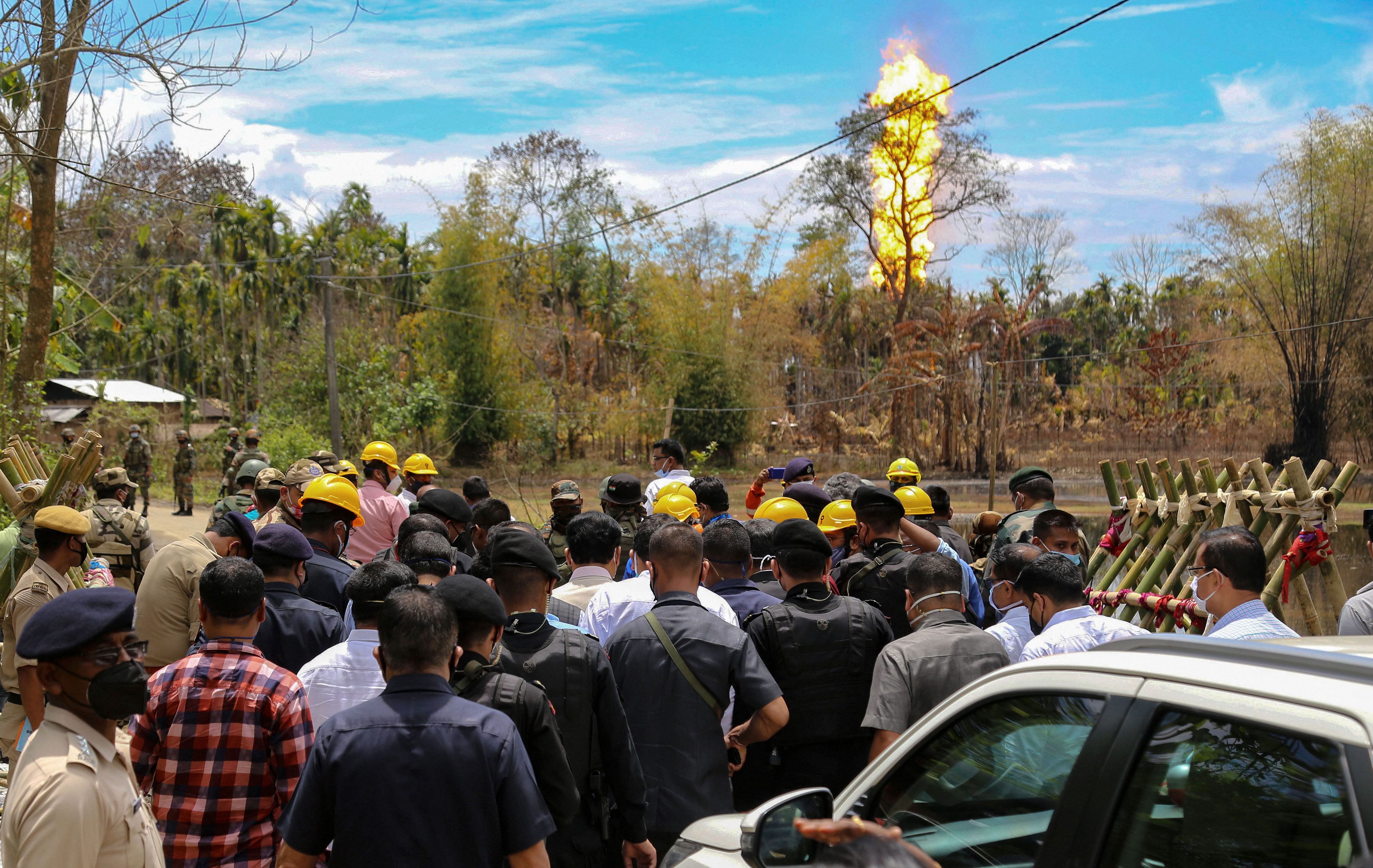 Assam Chief Minister Sarbananda Sonowal and Union Petroleum Minister Dharmendra Pradhan take stock of measures taken by experts to douse fire at Baghjan gas well site, in Tinsukia District, Sunday, June 14, 2020. (PTI Photo)