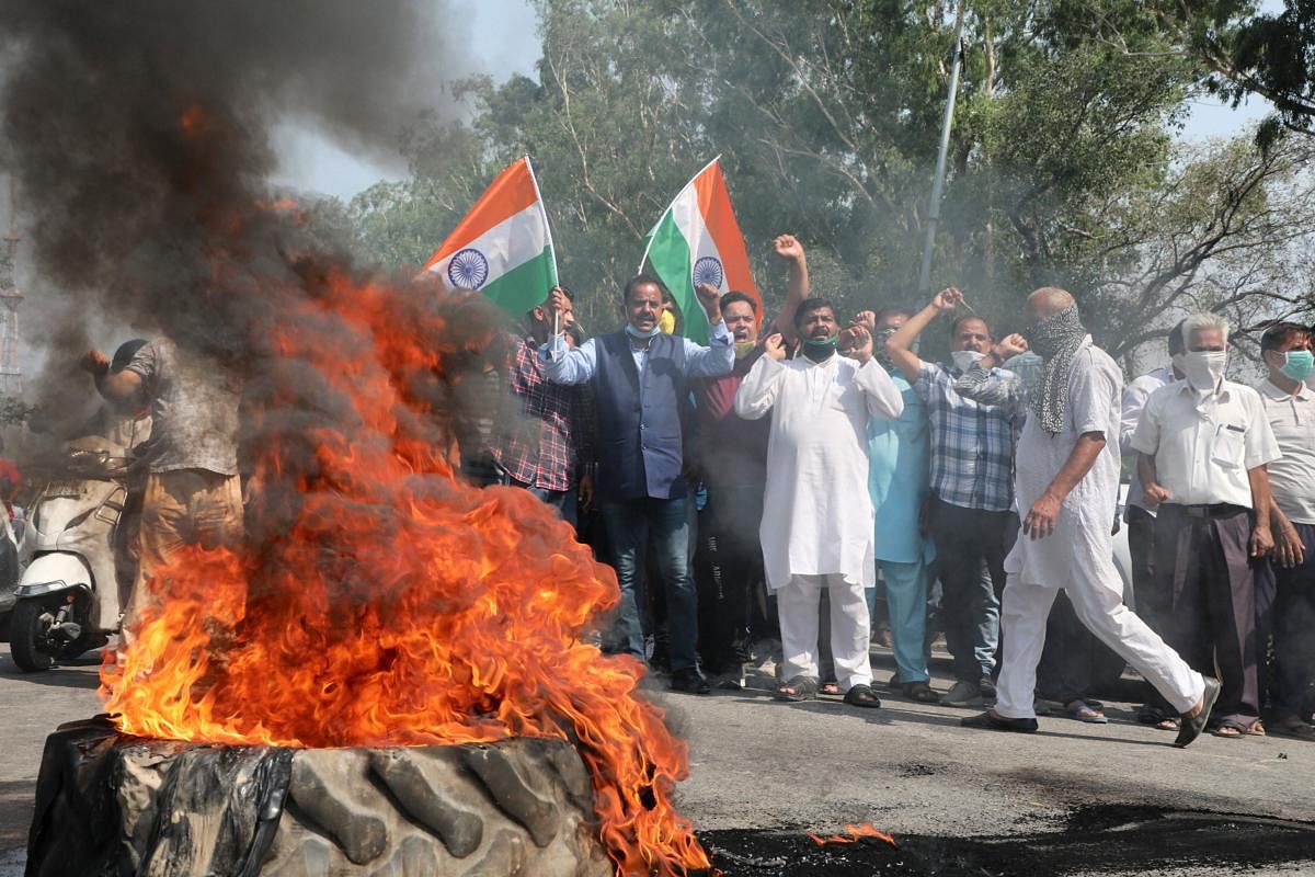 Demonstrators burn a tyre and block Jammu-Poonch highway during a protest against China on Indo-China clash at Galwan valley in Ladakh, in Jammu, Wednesday, June 17, 2020. Atleast 20 soldiers were martyred in the violent face-off. Credit: PTI