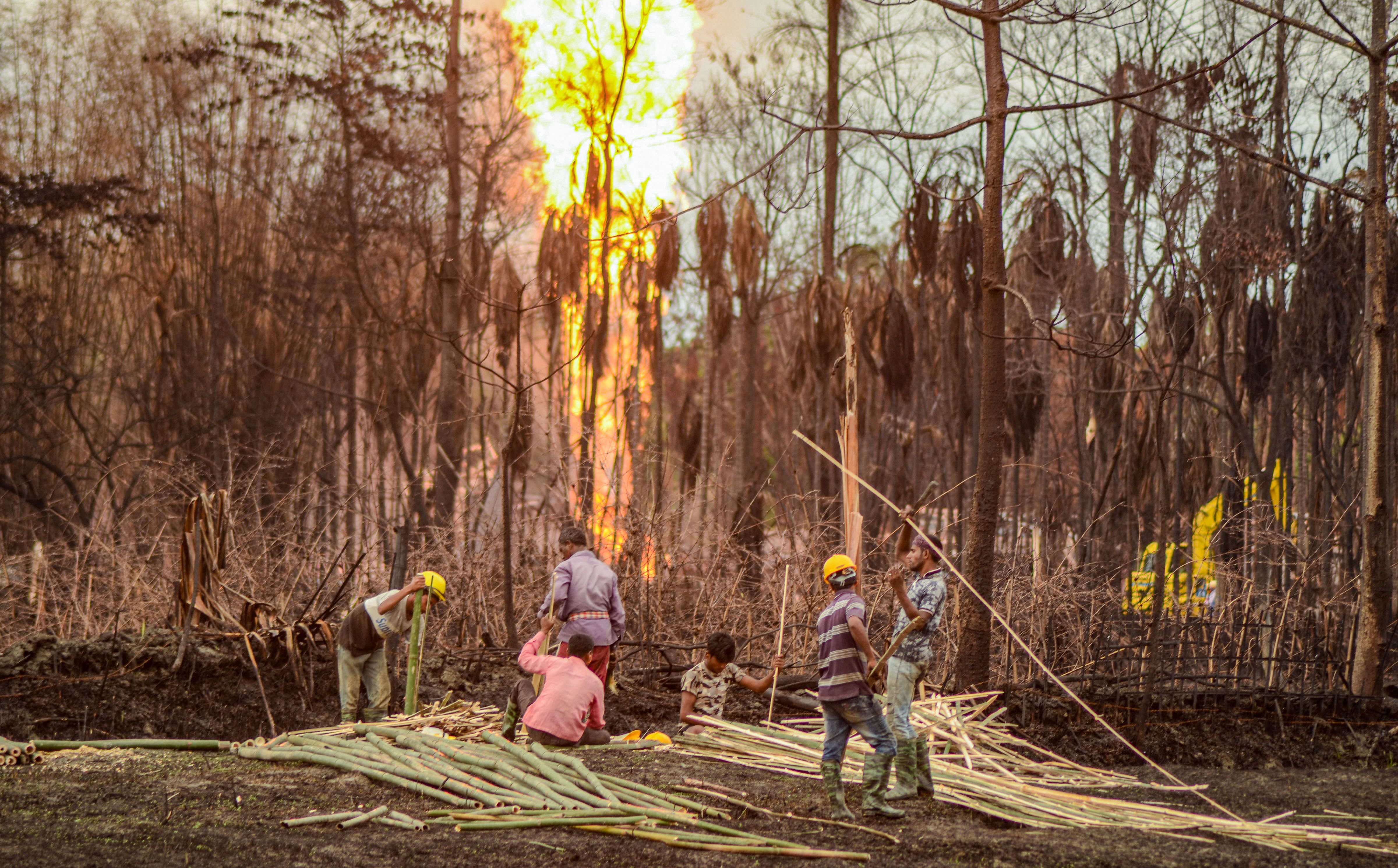 Workers build a structure near the gas well blowout site, during the ongoing COVID-19 nationwide lockdown, in Tinsukia district, Tuesday, June 16, 2020. (PTI Photo)