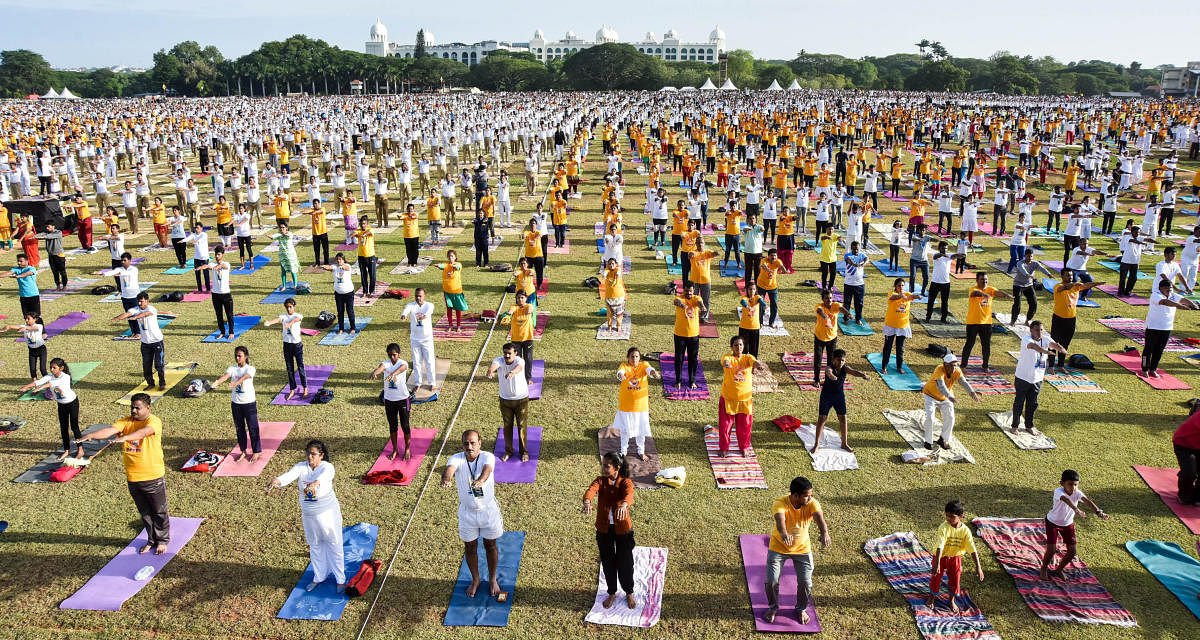 Yoga enthusiasts perform yoga during the previous International Yoga Day in Mysuru. Dh-file photo