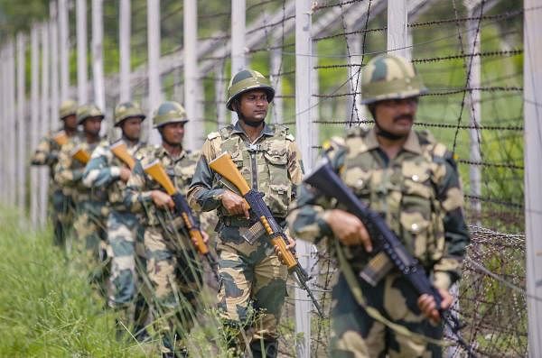 Border Security Force (BSF) soldiers patrol along the fencing at the international border ahead of Independence day, in Jammu, Wednesday, Aug 14, 2019. (PTI Photo)