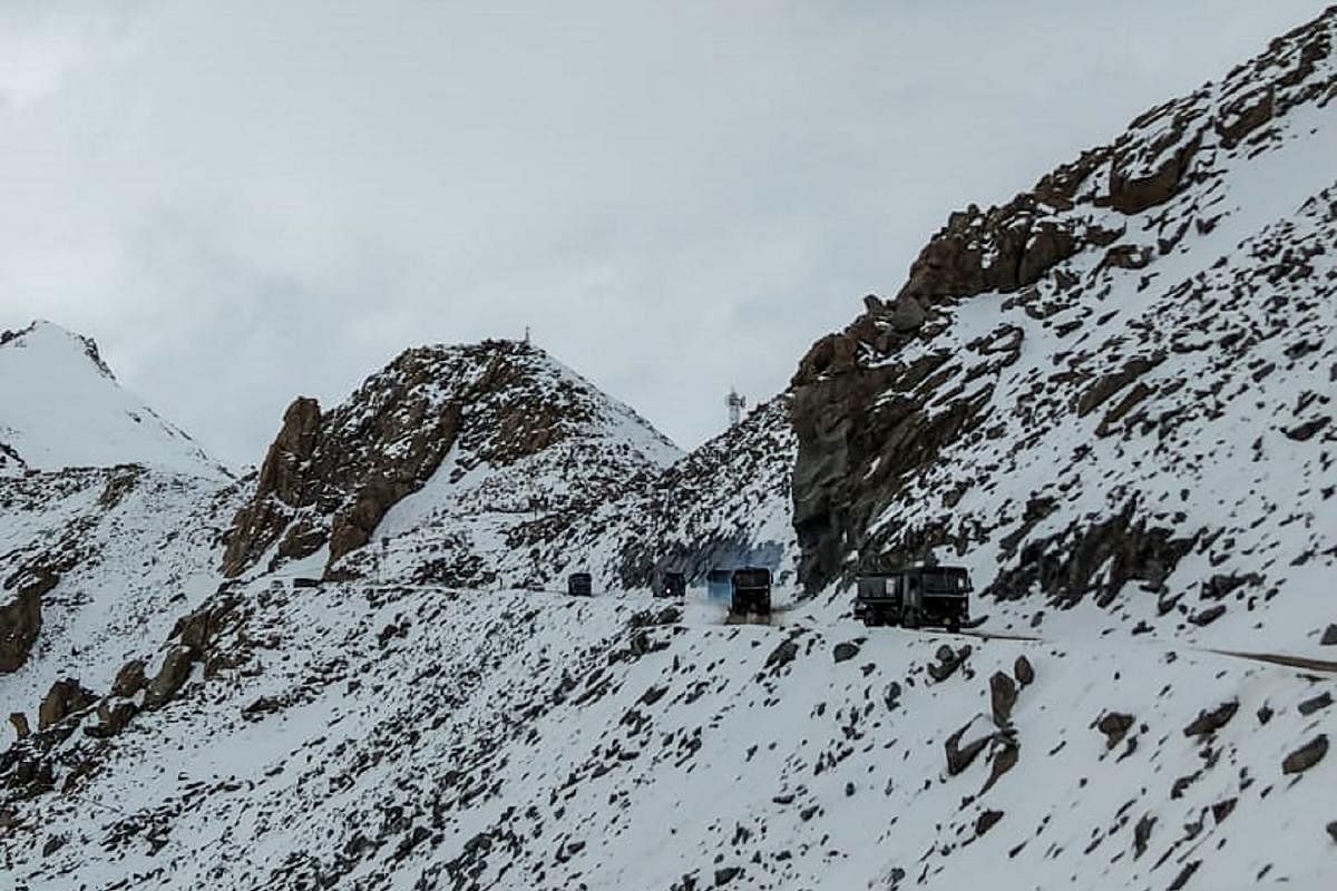 Indian Army vehicles drive on a road near Chang La high mountain pass in northern India's Ladakh region of Jammu and Kashmir state near the border with China on June 17, 2020. (AFP)