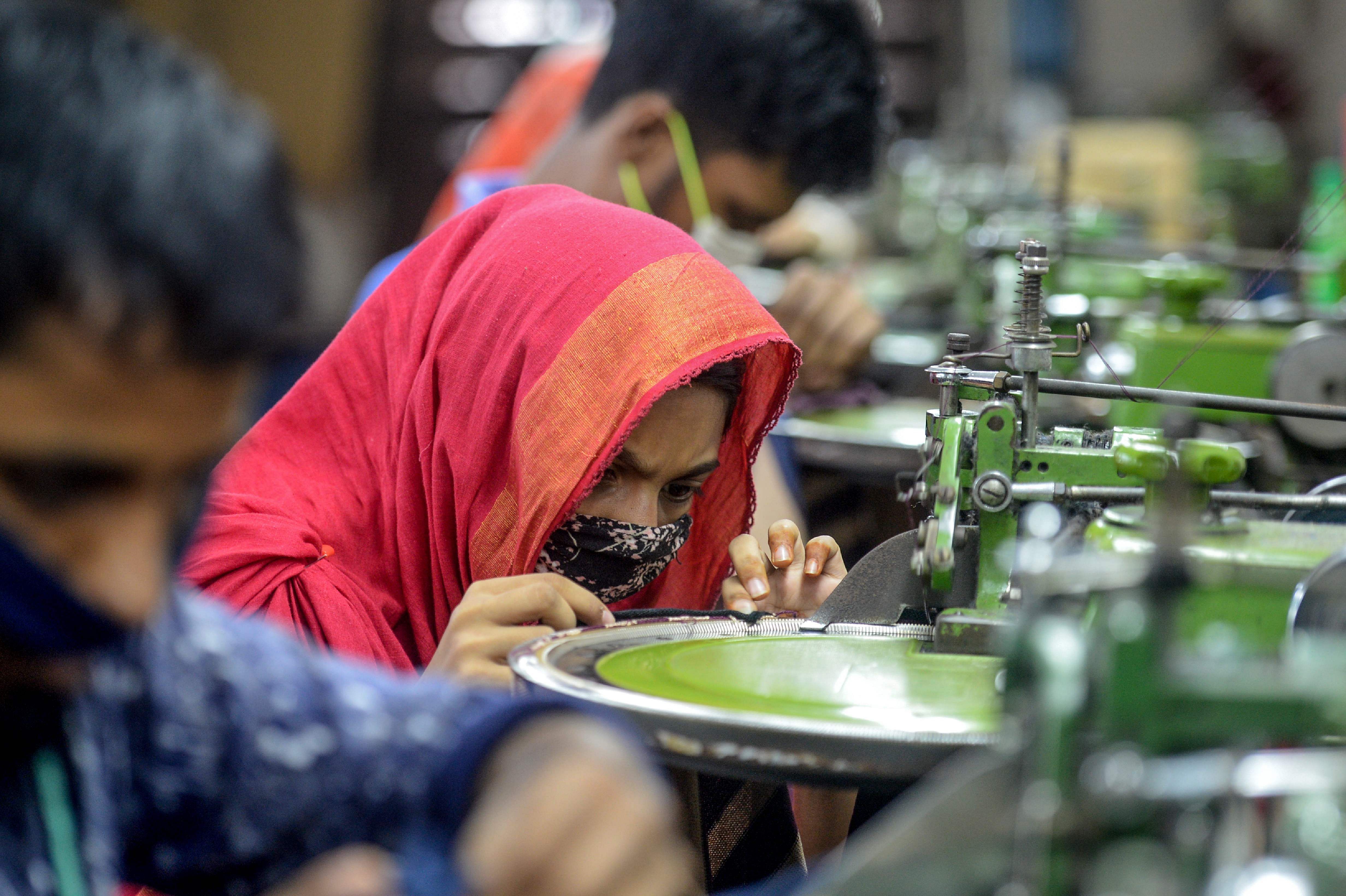 A labourer works in a garment factory in Savar on the outskirts of Dhaka. Credits: AFP Photo