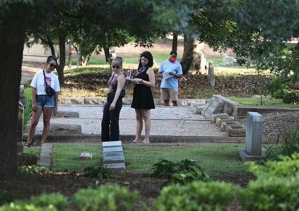 People visit the Black section of the historic Oakland cemetery on June 18, 2020 in Atlanta, Georgia. As ongoing protests against police brutality continue across America the Oakland cemetery held an hour long silent reflection and remembrance walk before Juneteenth. Credit: AFP Photo