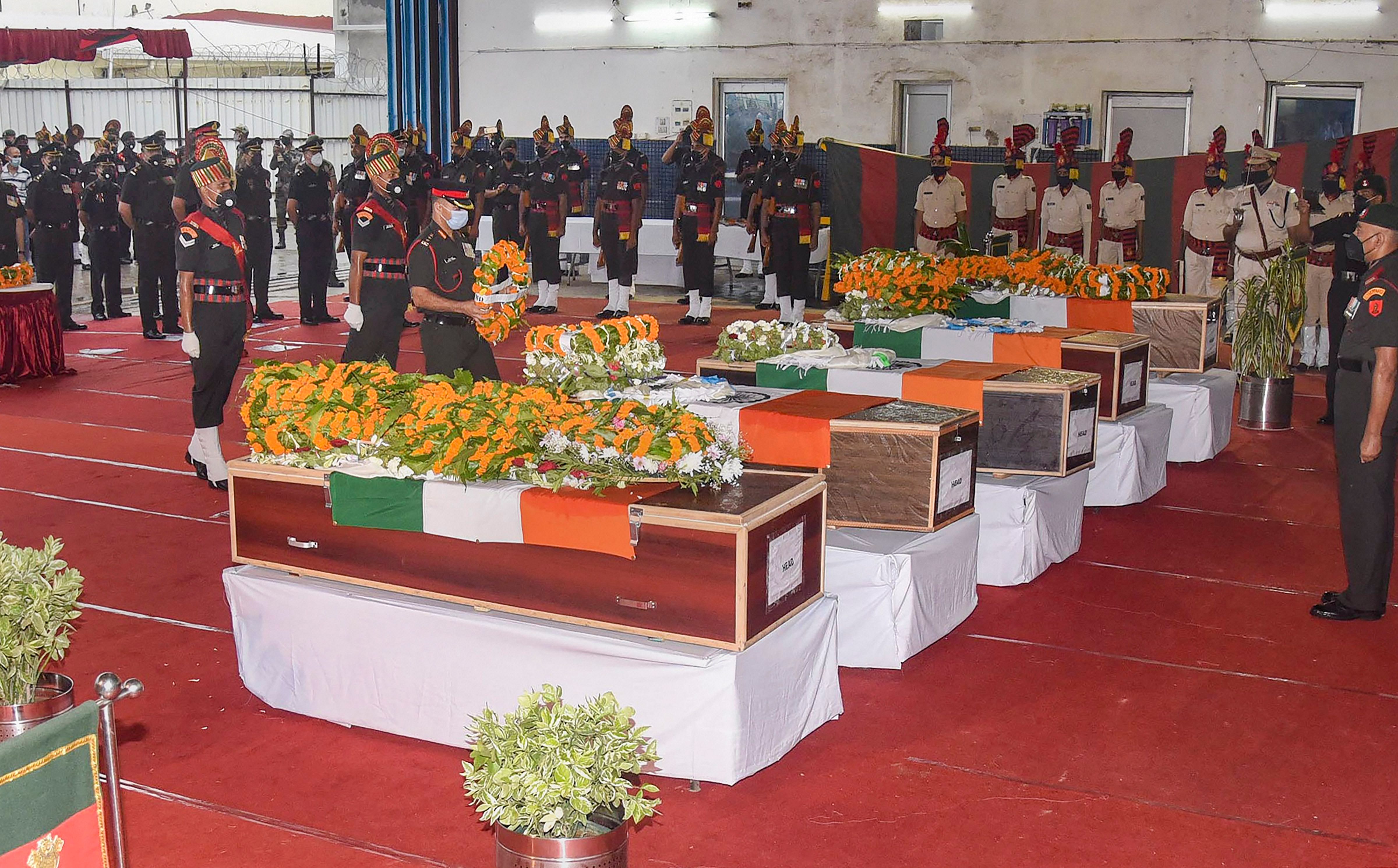 Army personnel pay tribute to the mortal remains of Bihar regimental jawans, who were killed during the face-off between Indian and Chinese troops in Ladakh's Galwan Valley, at Jaiprakash Narayan Airport in Patna, Thursday, June 18, 2020. (PTI Photo)