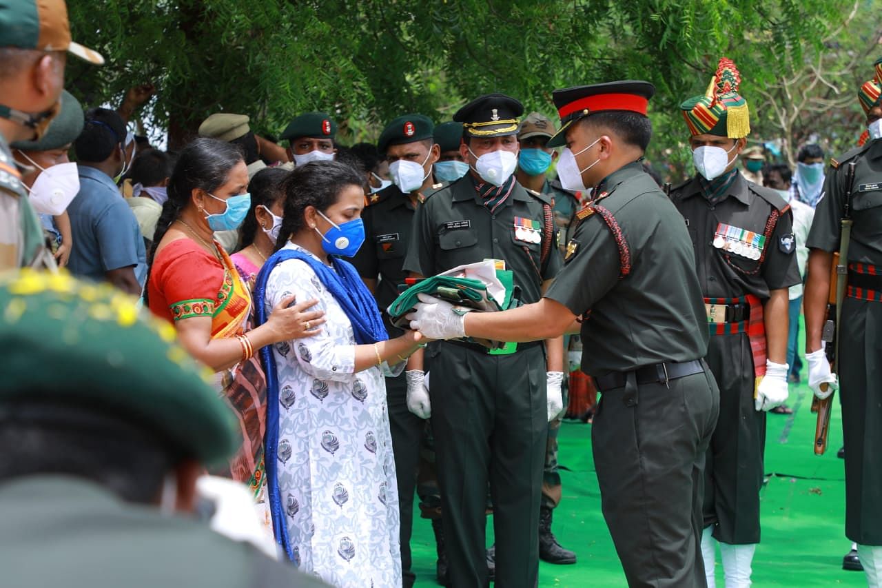 Colonel Santosh Babu’s last rites were conducted with full military honours on Thursday morning, in his farm at Kesaram close to his hometown Suryapet in Telangana.