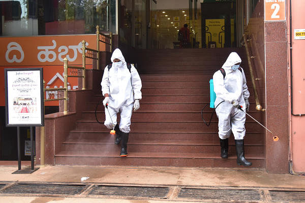 Workers sanitizing before opening the shops due to Coronavirus precaution in Covid 19 lockdown unlock at Safina plaza in Bengaluru on Thursday, 18 June 2020. Photo by S K Dinesh