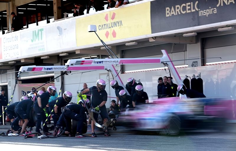 Engineers practice a pit stop on Racing Point's Sergio Perez during testing. Credits: Reuters Photo