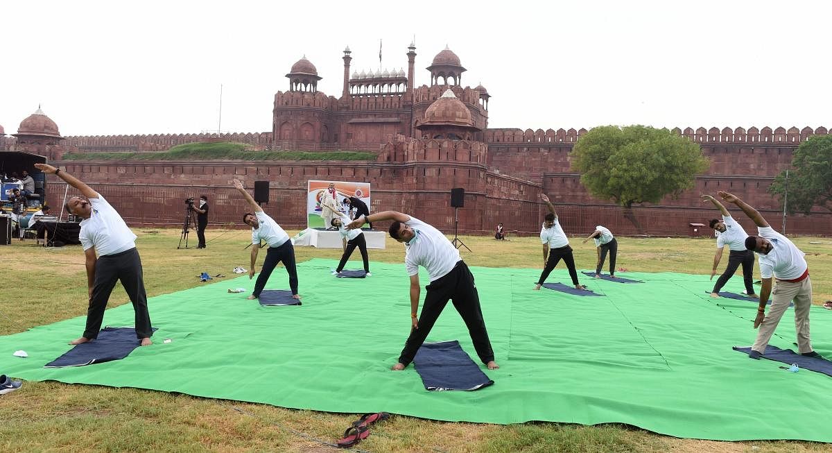 Police personnel perform yoga in front of Red Fort on the occasion of International Yoga Day, in New Delhi, Sunday, June 21, 2020. Credit: PTI