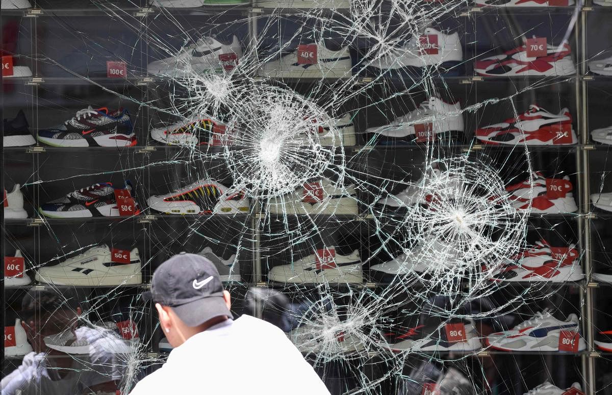 A broken shop window of a shoe store is pictured in Stuttgart, southern Germany on June 21, 2020. Credit: AFP