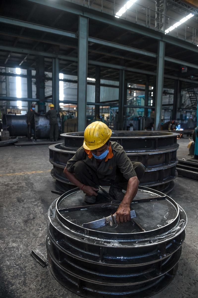 A labourer works at DH Cube Industries, a heavy manufacturing factory, after the government eased a nationwide lockdown as a preventive measure against the COVID-19 coronavirus at Vasna Buzarg village, some 40 kms from Ahmedabad. AFP