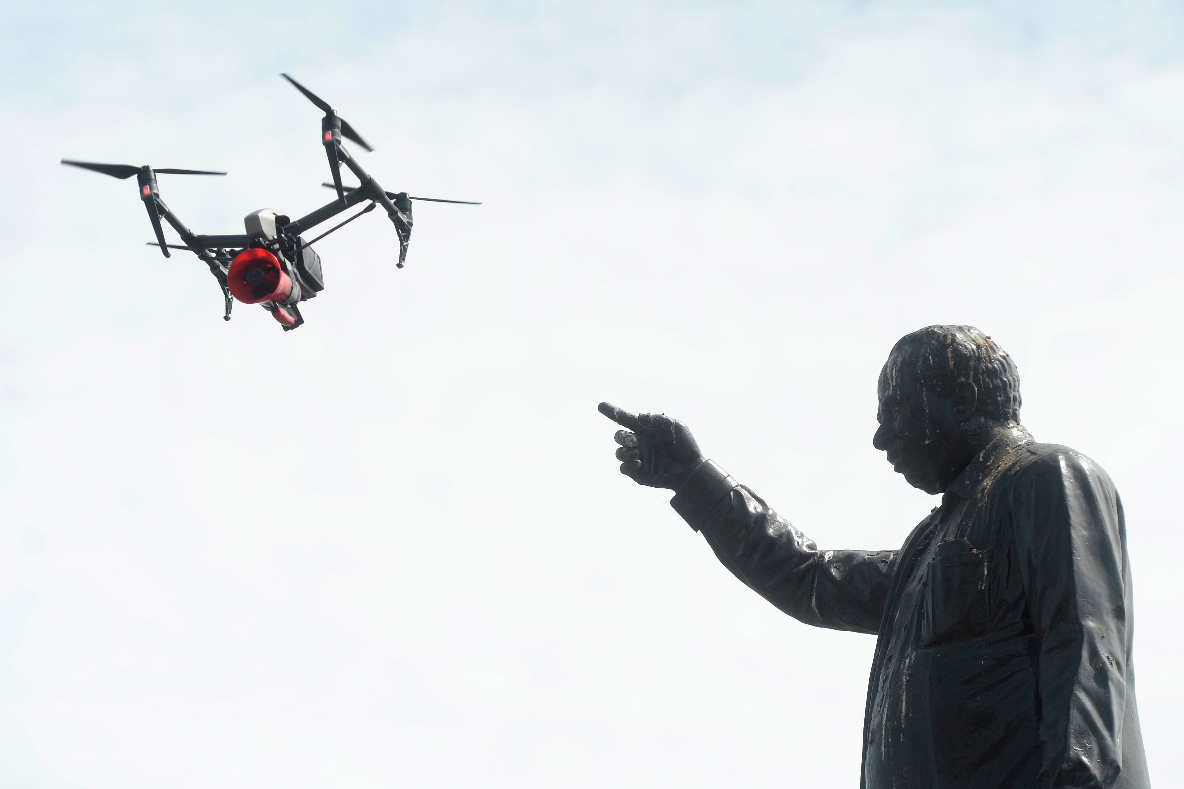 A drone being used by police to monitor activities of people and to spread awareness announcements is pictured next to a statue of late former chief minister of Tamil Nadu C. N. Annadurai, after a lockdown was reimposed as a preventive measure against the spread of the COVID-19, in Chennai on June 19, 2020. (PTI Photo)