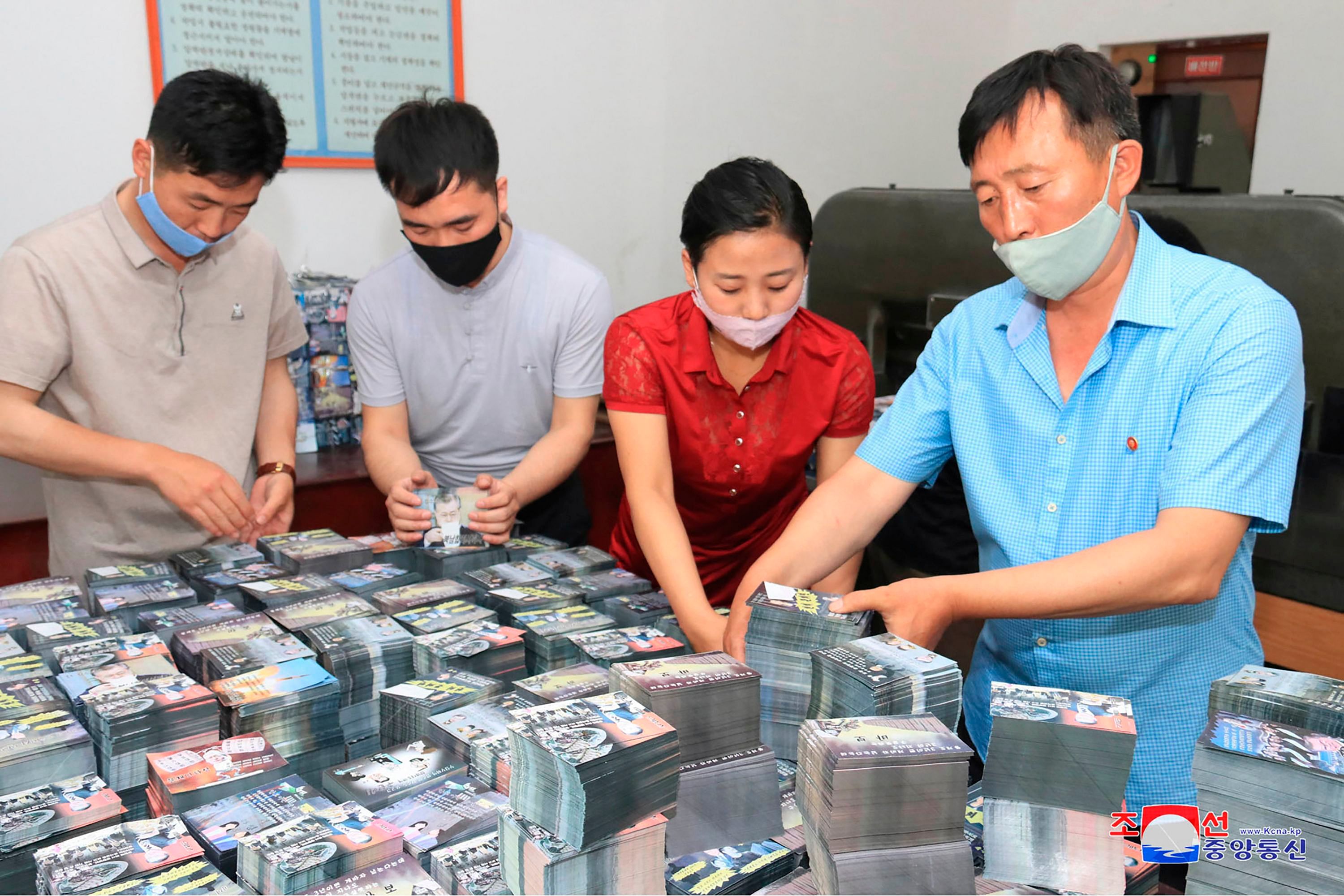 North Koreans preparing anti-Seoul leaflets at an undisclosed location in North Korea. Credits: AFP Photo