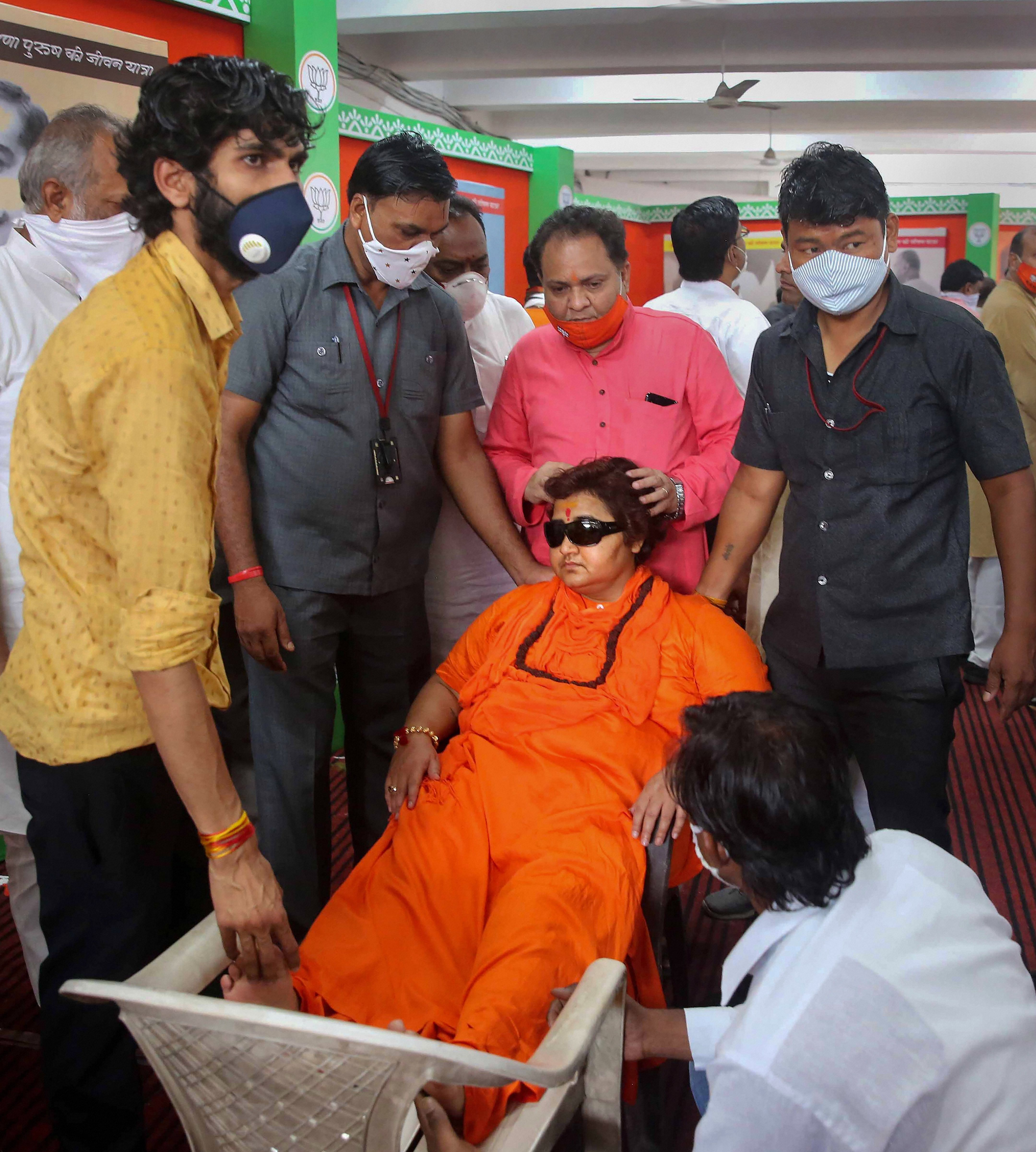 BJP MP from Bhopal Sadhvi Pragya Singh Thakur takes rest after she complained of uneasiness during the inauguration of a photo exhibition on life history of Jansangh founder leader Pt Shyama Prasad Mookerjee, organised on his death anniversary, at BJP State headquarters in Bhopal, Tuesday, June 23, 2020. (PTI Photo)