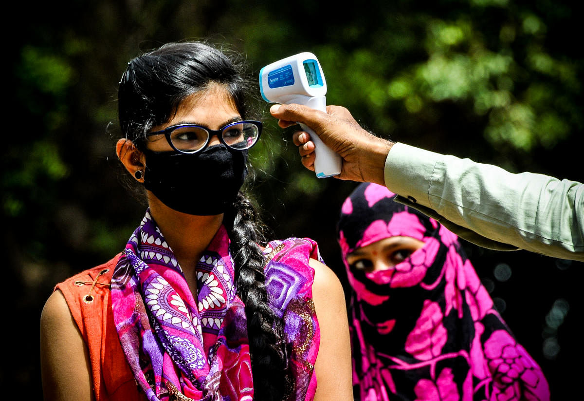 A student undergoes thermal screening during the demonstration for SSLC examinations, at Lamington School in Hubballi on Tuesday.