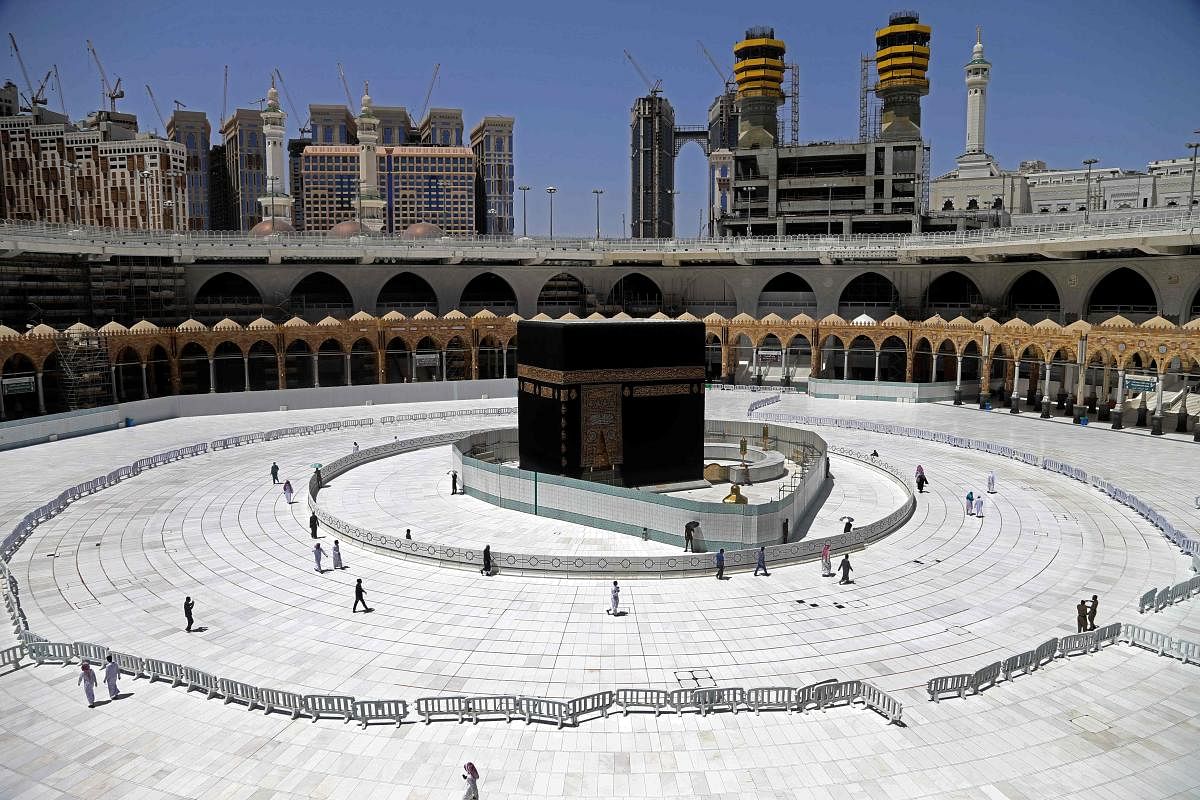  In this file photo taken on April 3, 2020 Muslim worshippers walk around the sacred Kaaba in Mecca's Grand Mosque, Islam's holiest site, during the coronavirus Covid-19 pandemic. Credit/AFP Photo