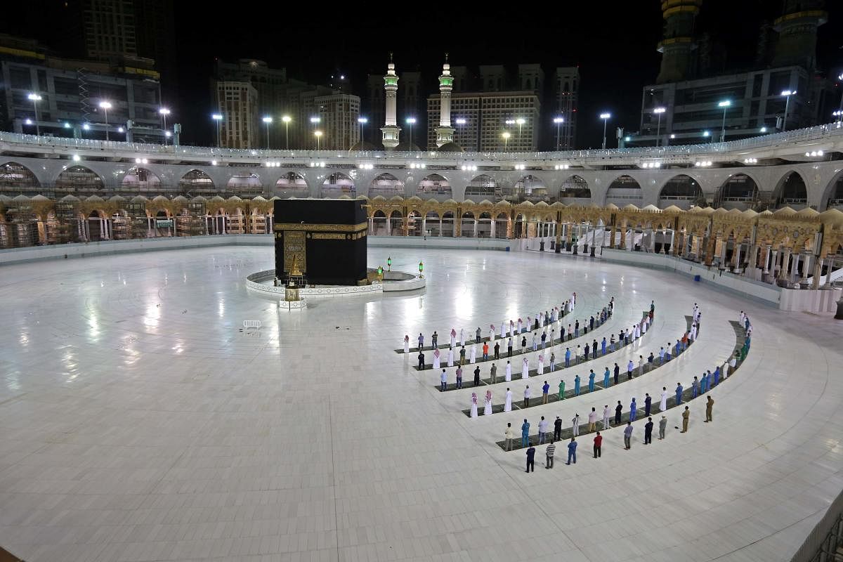  A picture taken June 23, 2020 shows a few worshippers performing al-Fajr prayer at the Kaaba, Islam's holiest shrine, at the Grand Mosque complex in Saudi Arabia's holy city of Mecca. Credit/AFP Photo