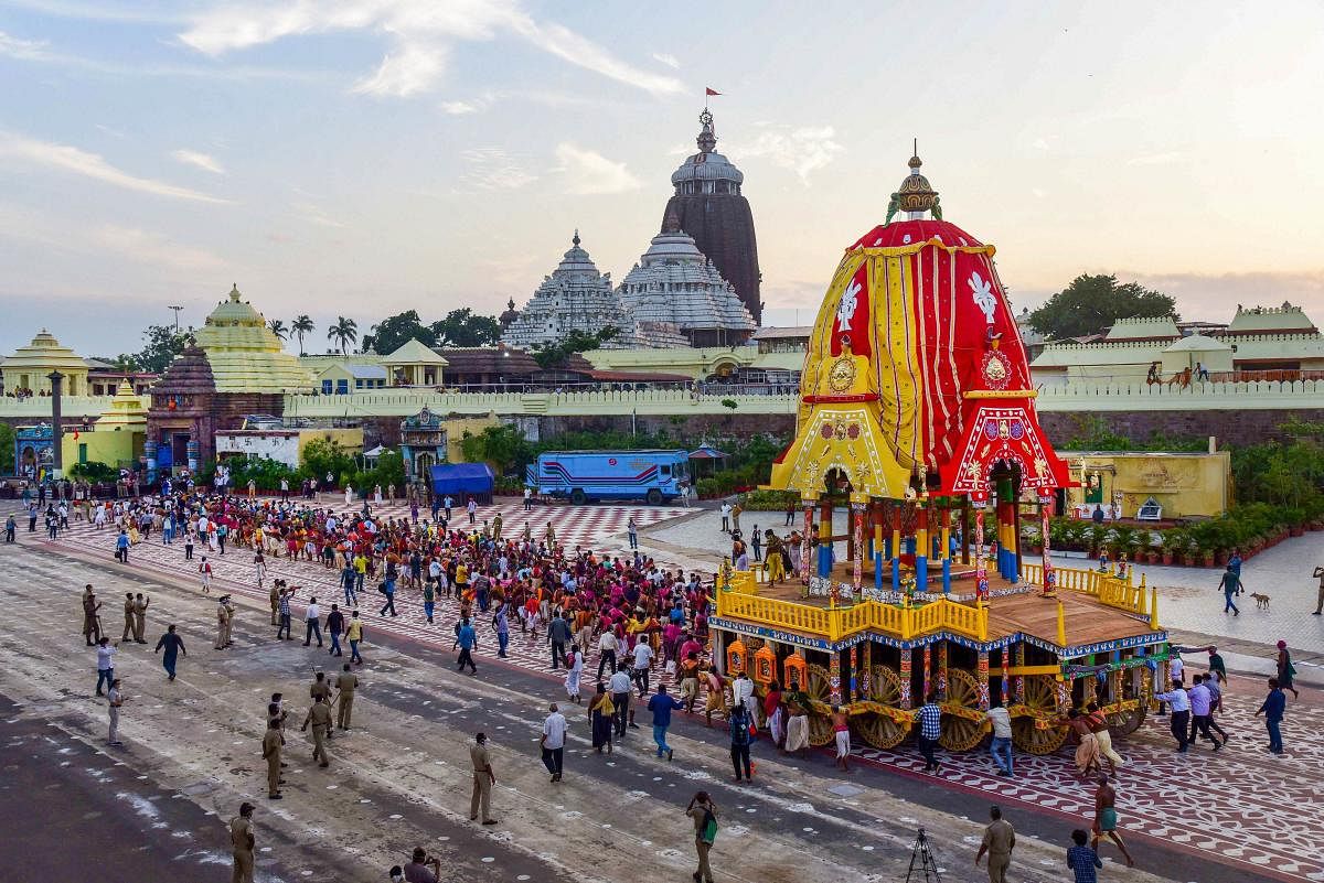 Priests and policemen pull the three chariots of Lord Jagannath, Balarama, and Subhadra from the construction site (Ratha Khala) to Jagannatha Temple for the annual Rath Yatra, on Monday, June 22, 2020. Credit/PTI Photo