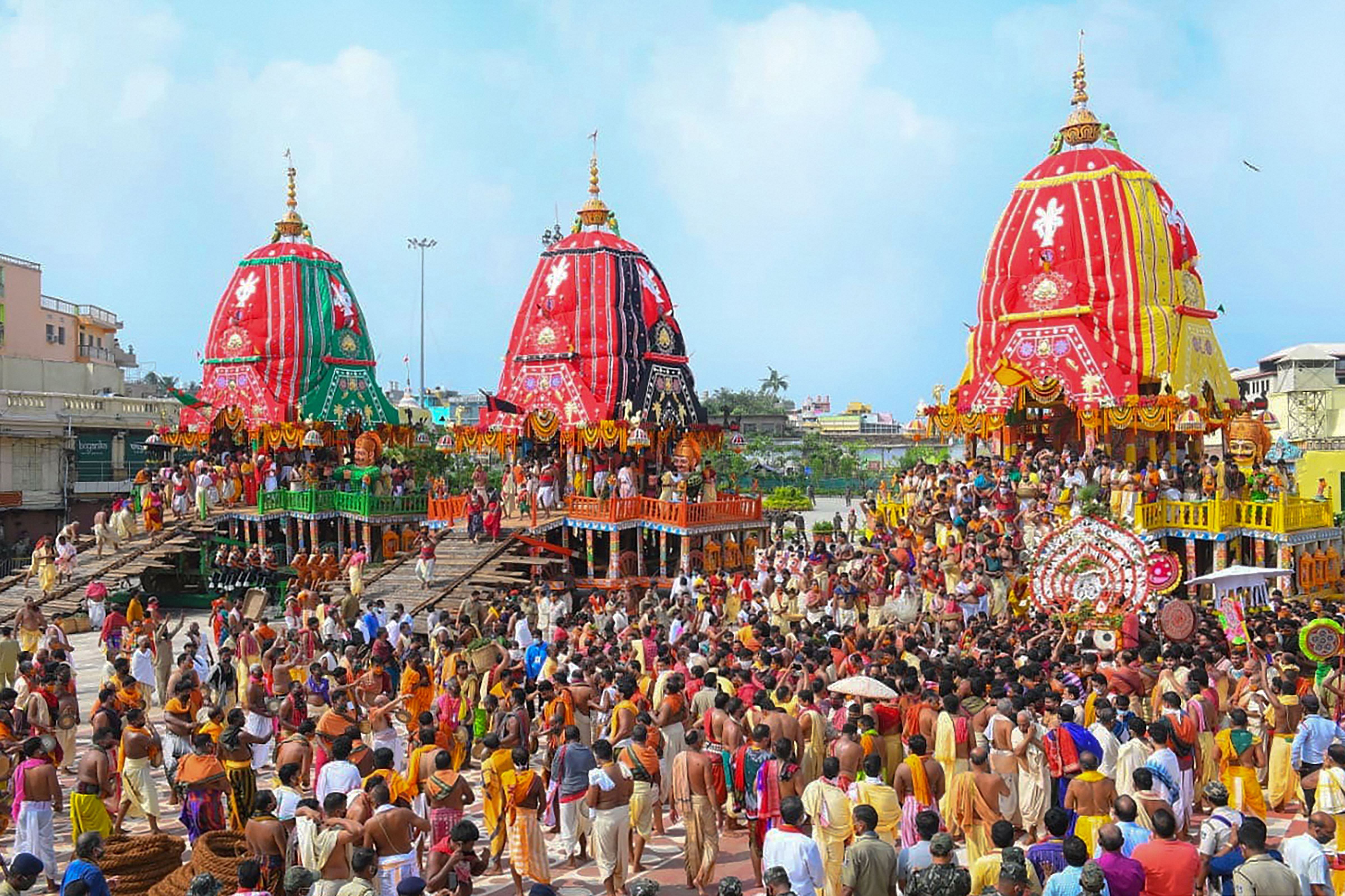 Priests and devotees take part in the 'pahandi' rituals of Lord Jagannath Rath Yatra in Puri, Tuesday, June 23, 2020. The Rath Yatra is being organised in a restricted manner this year due to the COVID-19 pandemic. (PTI Photo)