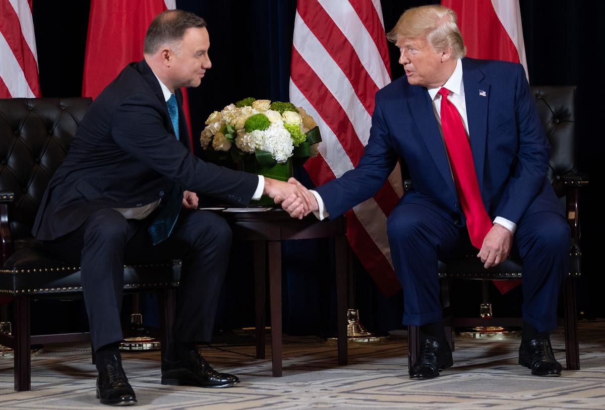  In this file photo taken on September 23, 2019 US President Donald Trump shakes hands with Polish President Andrzej Duda during a meeting on the sidelines of the UN General Assembly in New York. Credit/AFP File Photo