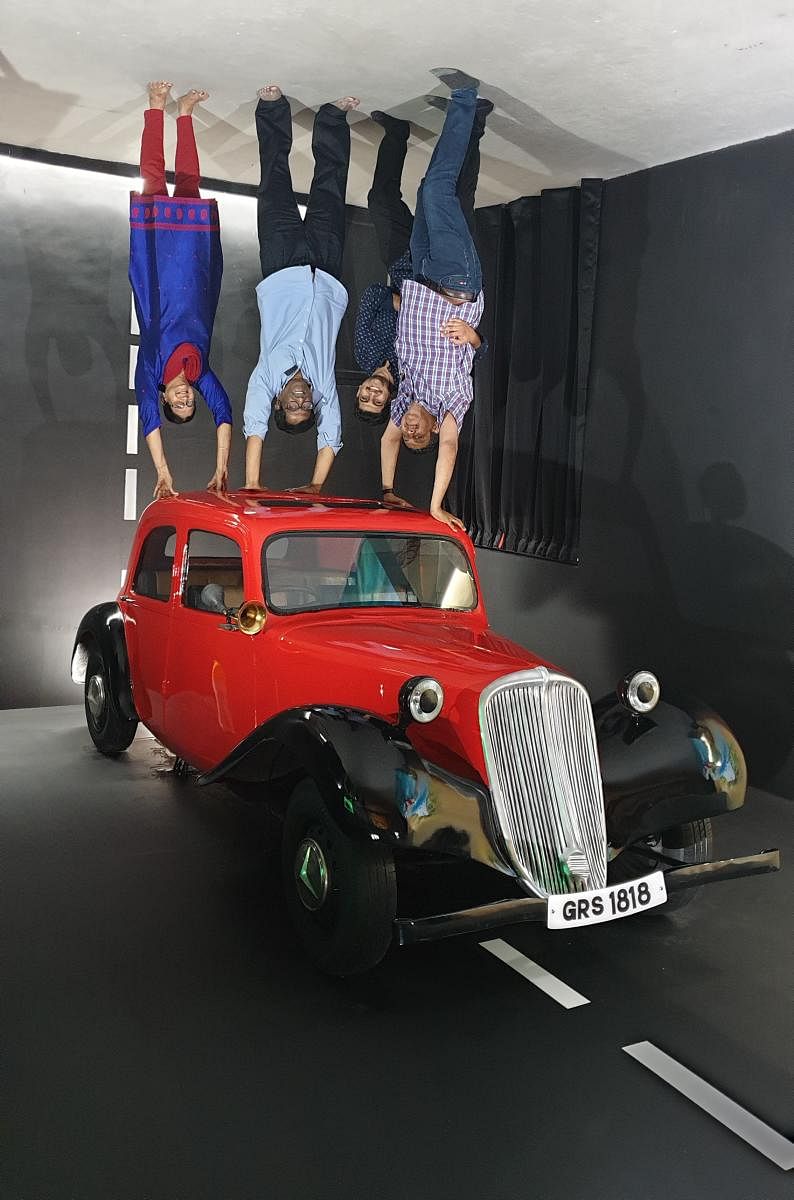 Visitors feel inverted car experience at GRS Fantasy Park in Mysuru recently.