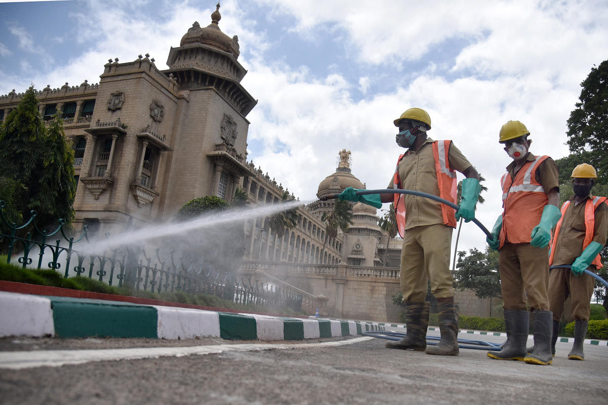 Workers sanitise Vidhana Soudha premises. Photo by S K Dinesh