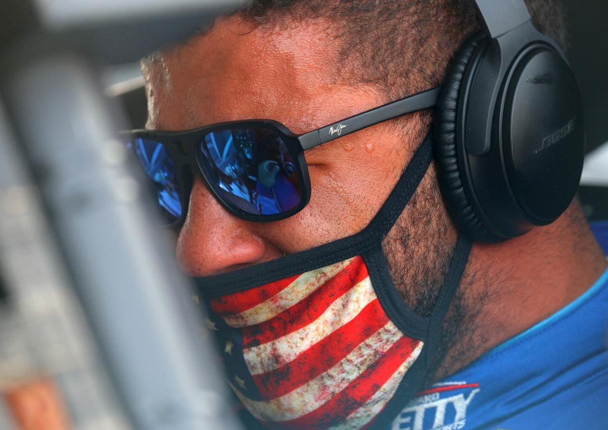 Bubba Wallace, driver of the #43 Victory Junction Chevrolet, stands on the grid prior to the NASCAR Cup Series GEICO 500 at Talladega Superspeedway on June 22, 2020 in Talladega, Alabama. A noose was found in the garage stall of NASCAR driver Bubba Wallace at Talladega Superspeedway a week after the organization banned the Confederate flag at its facilities. Credit/AFP Photo