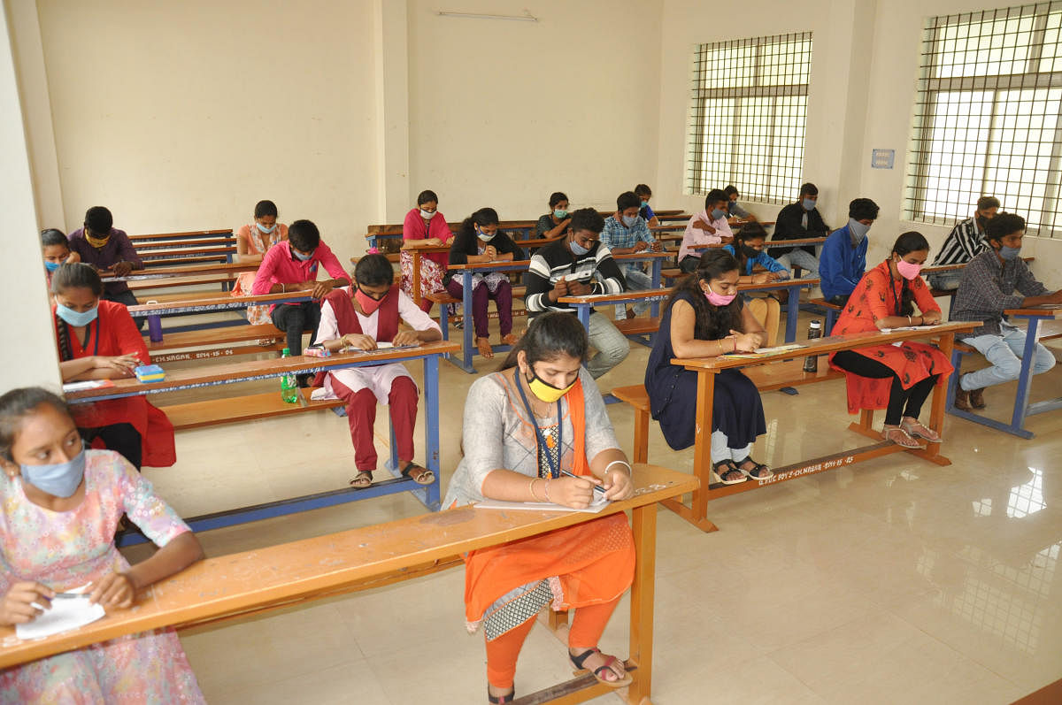 Students checks registration numbers before day of SSLC exam at Vijaya High School at Jayanagar in Bengaluru on Wednesday, 24 June, 2020. Photo by B K Janardhan