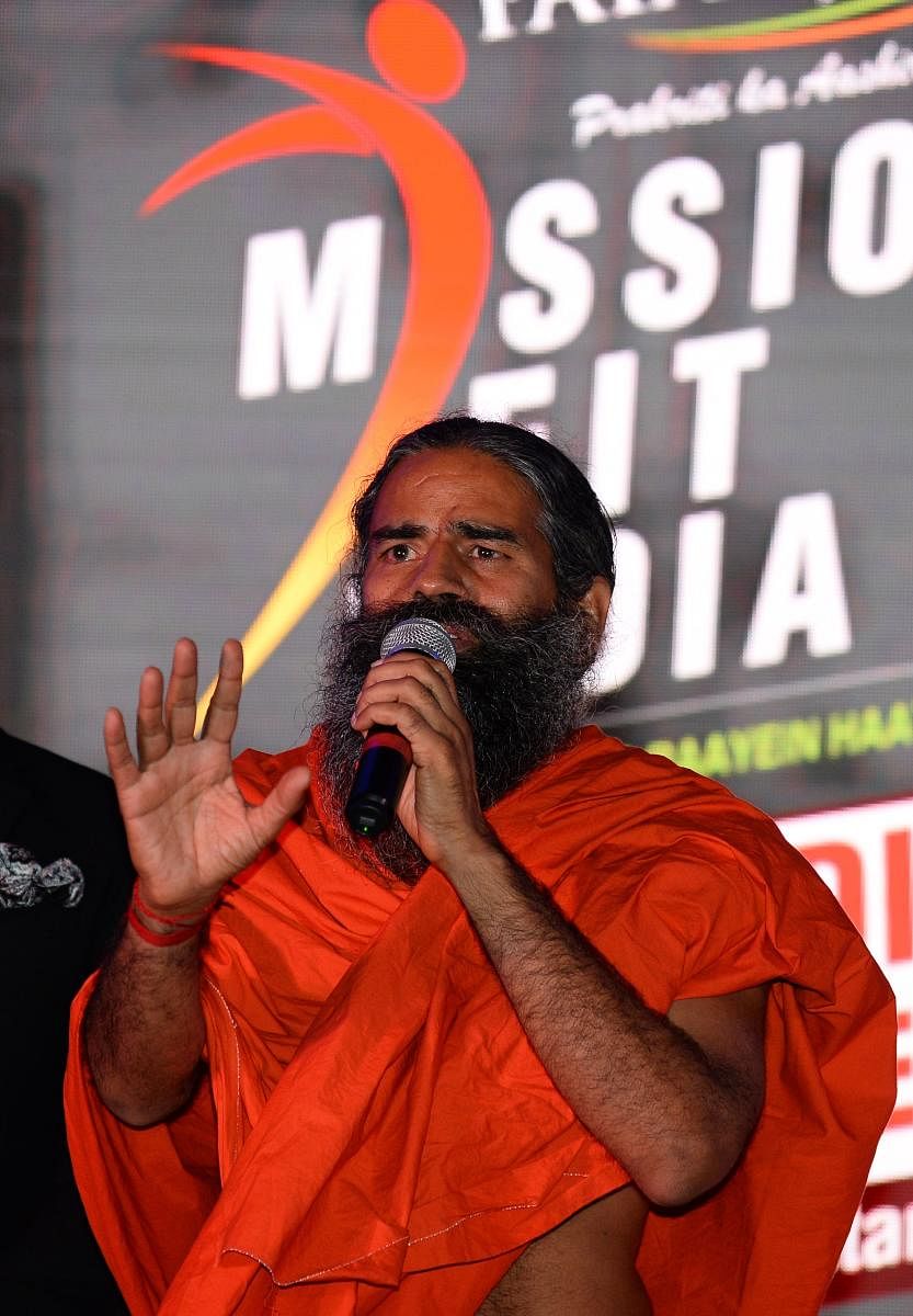 (FILES) In this file photo taken on June 4, 2018 Indian yoga guru Baba Ramdev speaks to media during a promotional event in New Delhi. - India's best known guru announced on June 23 the launch by his Ayurvedic consumer goods corporation of two herbal reme