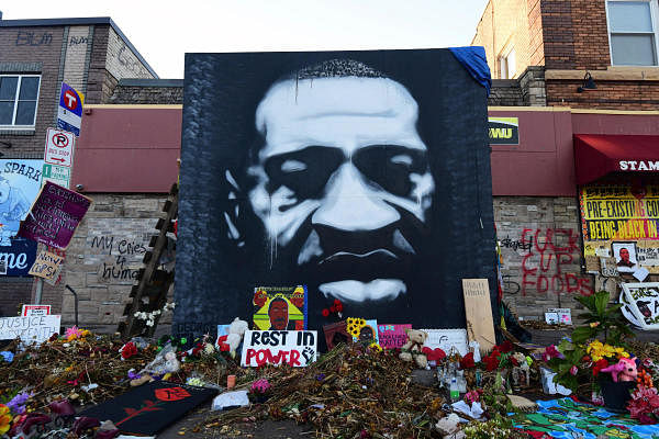 A memorial to George Floyd, who died after a white Minneapolis police officer pressed his knee into his neck on May 25, is lit by morning light one month later in Minneapolis, Minnesota, U.S. June 25, 2020. Credit: REUTERS