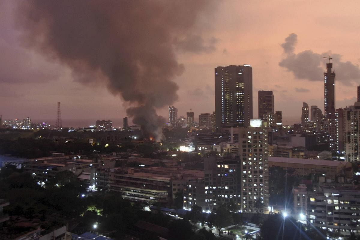 Smoke billows from Raghuvanshi mill compound after a fire broke out in it, at Lower Parel in Mumbai. PTI