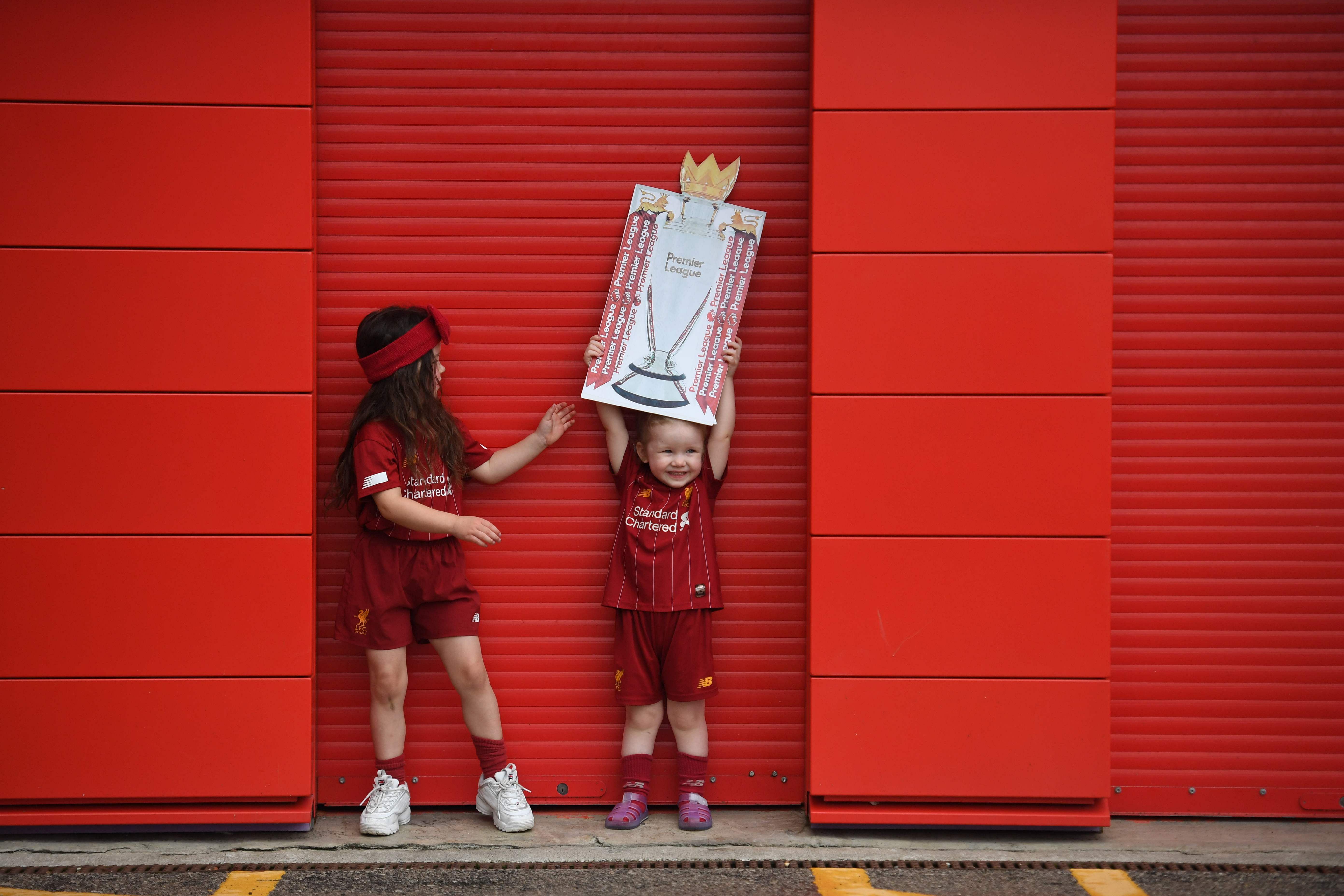 Liverpool were crowned Premier League champions without kicking a ball on Thursday as Chelsea's 2-1 win over Manchester City ended the Reds' 30-year wait to win the English title. Jurgen Klopp's men sealed a 19th league title for the club with a record seven games left to play after City's defeat left them 23 points adrift of Liverpool at the top. (Photo by AFP)