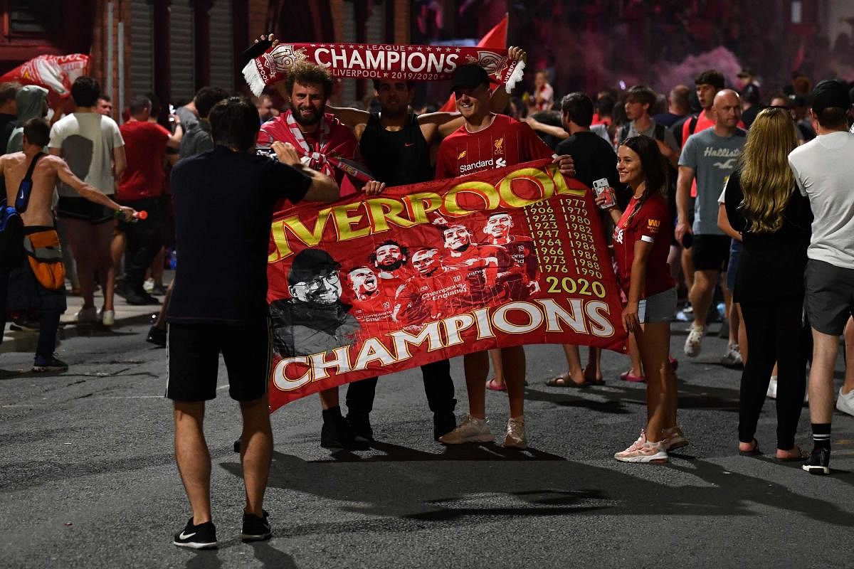 Fans celebrate Liverpool winning the Premier League title outside Anfield stadium in Liverpool, north west England on June 25, 2020, following Chelsea's 2-1 victory over Manchester City. Credit/AFP Photo