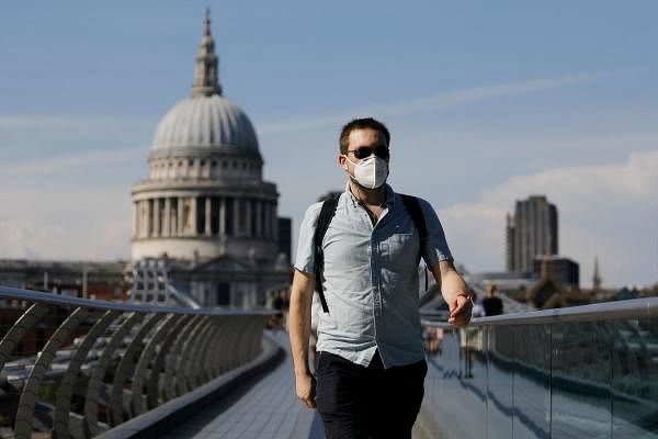 A pedestrian walks over The Millennium Bridge away from St Paul's Cathedral in London on June 26, 2020, as temperatures are expected to again be high, hitting 31 degrees Celsius in London. Credit: AFP Photo